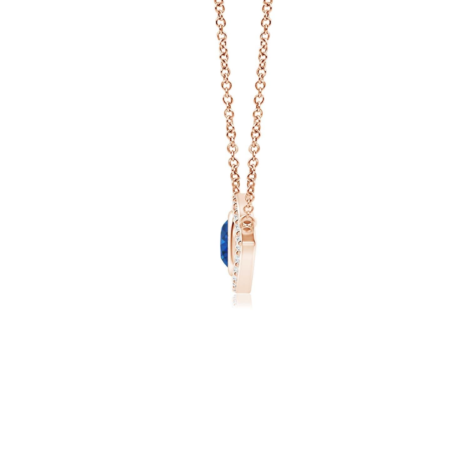 Hanging gracefully from a shiny metal bale is a diamond studded frame with a round sapphire bezel set at the center. The sparkling diamonds create a compelling contrast against the deep blue sapphire. Crafted in 14k rose gold, this sapphire evil eye