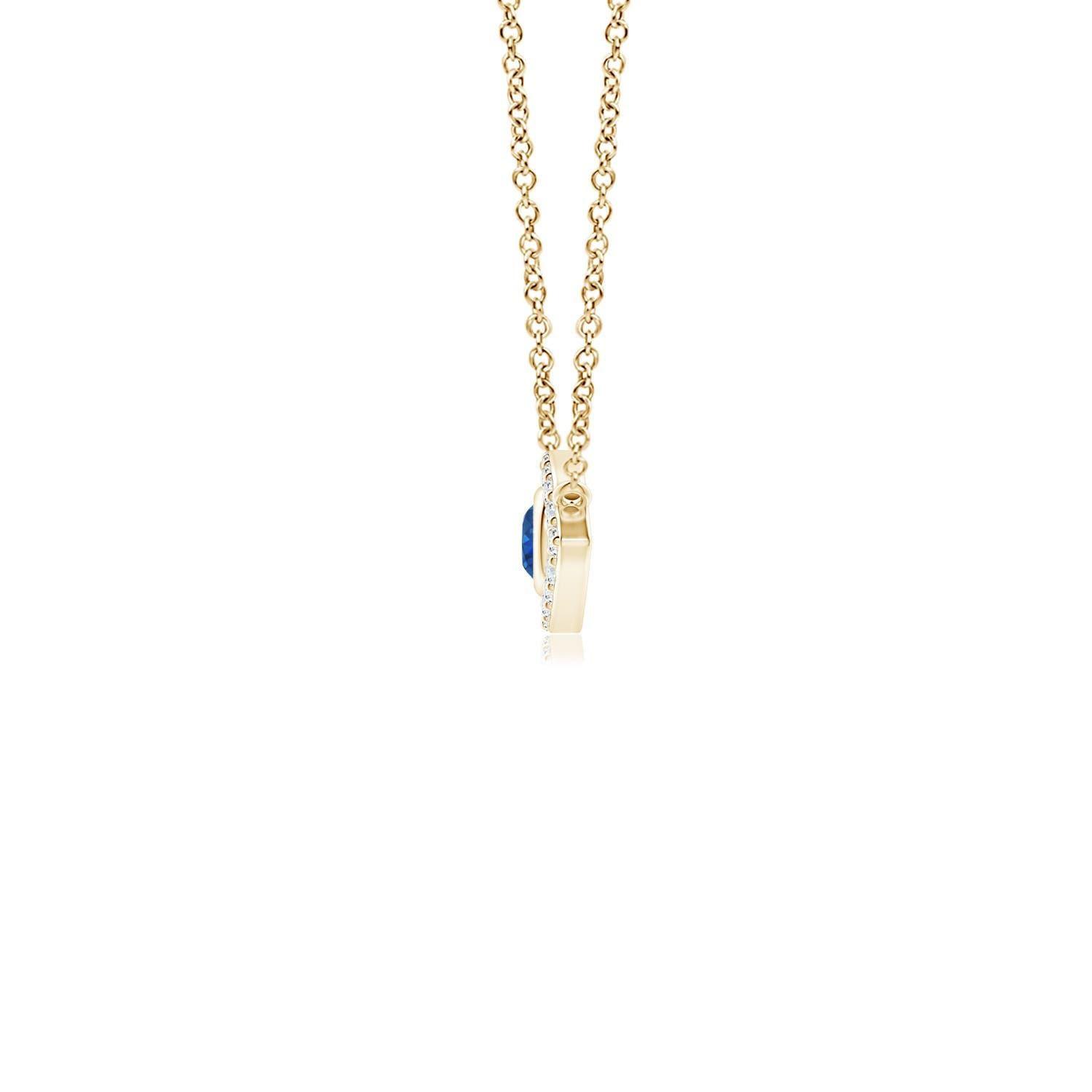 Hanging gracefully from a shiny metal bale is a diamond studded frame with a round sapphire bezel set at the center. The sparkling diamonds create a compelling contrast against the deep blue sapphire. Crafted in 14k yellow gold, this sapphire evil