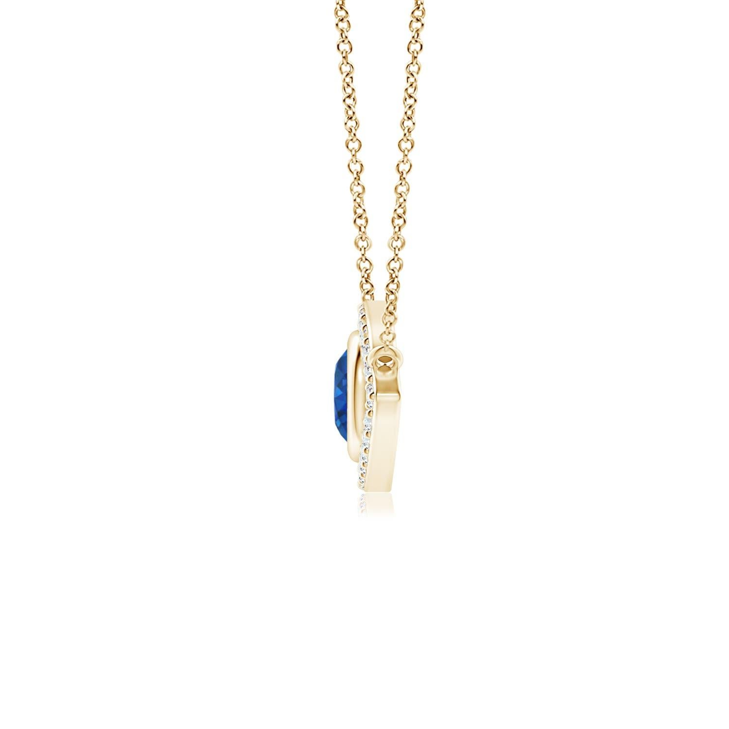 Hanging gracefully from a shiny metal bale is a diamond studded frame with a round sapphire bezel set at the center. The sparkling diamonds create a compelling contrast against the deep blue sapphire. Crafted in 14k yellow gold, this sapphire evil