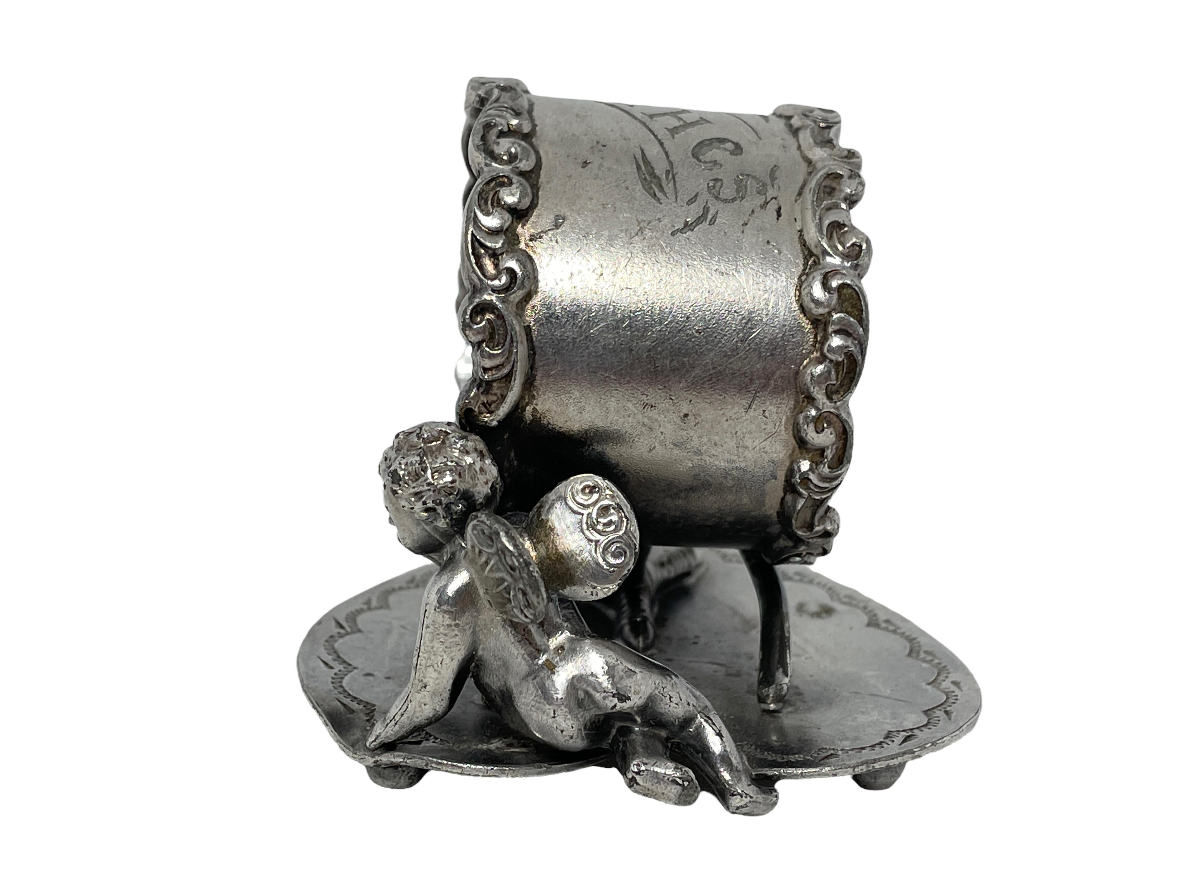 A beautiful silver plated figural napkin ring in the form of cherub angel, circa 1900s, made by Wilcox, England. Nice addition to every table. Some patina, but this is old-age.
 
