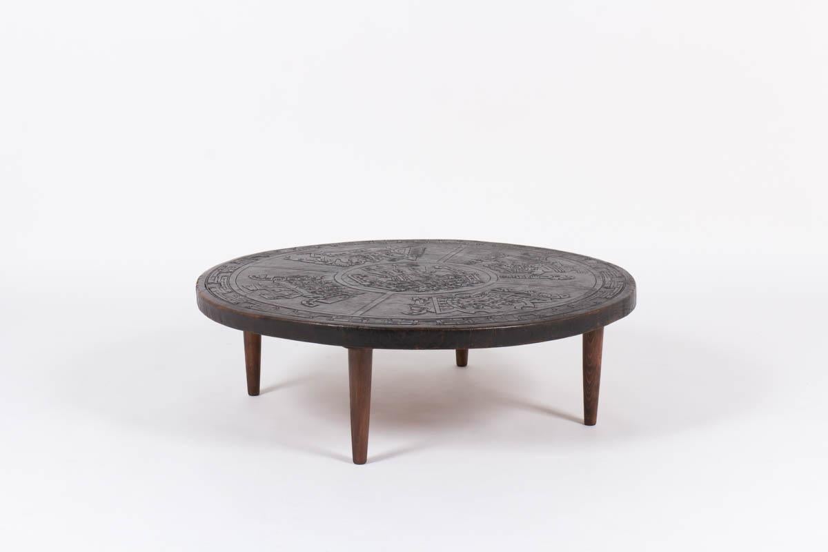 Description: this round coffee table was made by Angel I Pazmino for Muebles de Estilo during the sixties. It is composed of a structure in solid teak covered with a black thick leather. The leather is embossed with different Inca patterns visible