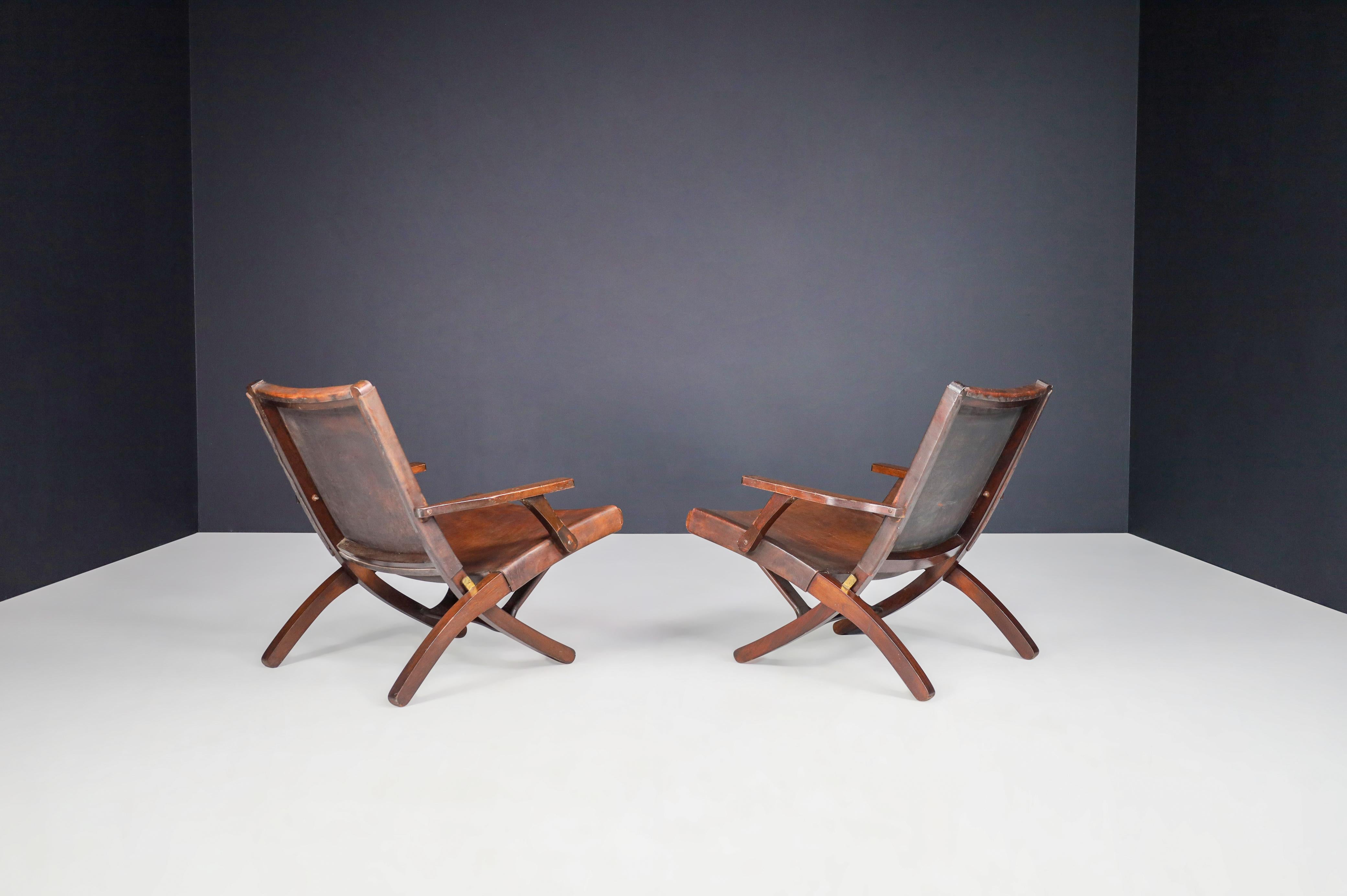 Late 20th Century Angel I. Pazmino Cognac-colored Saddle Leather Arm Chairs Ecuador 1970s   For Sale