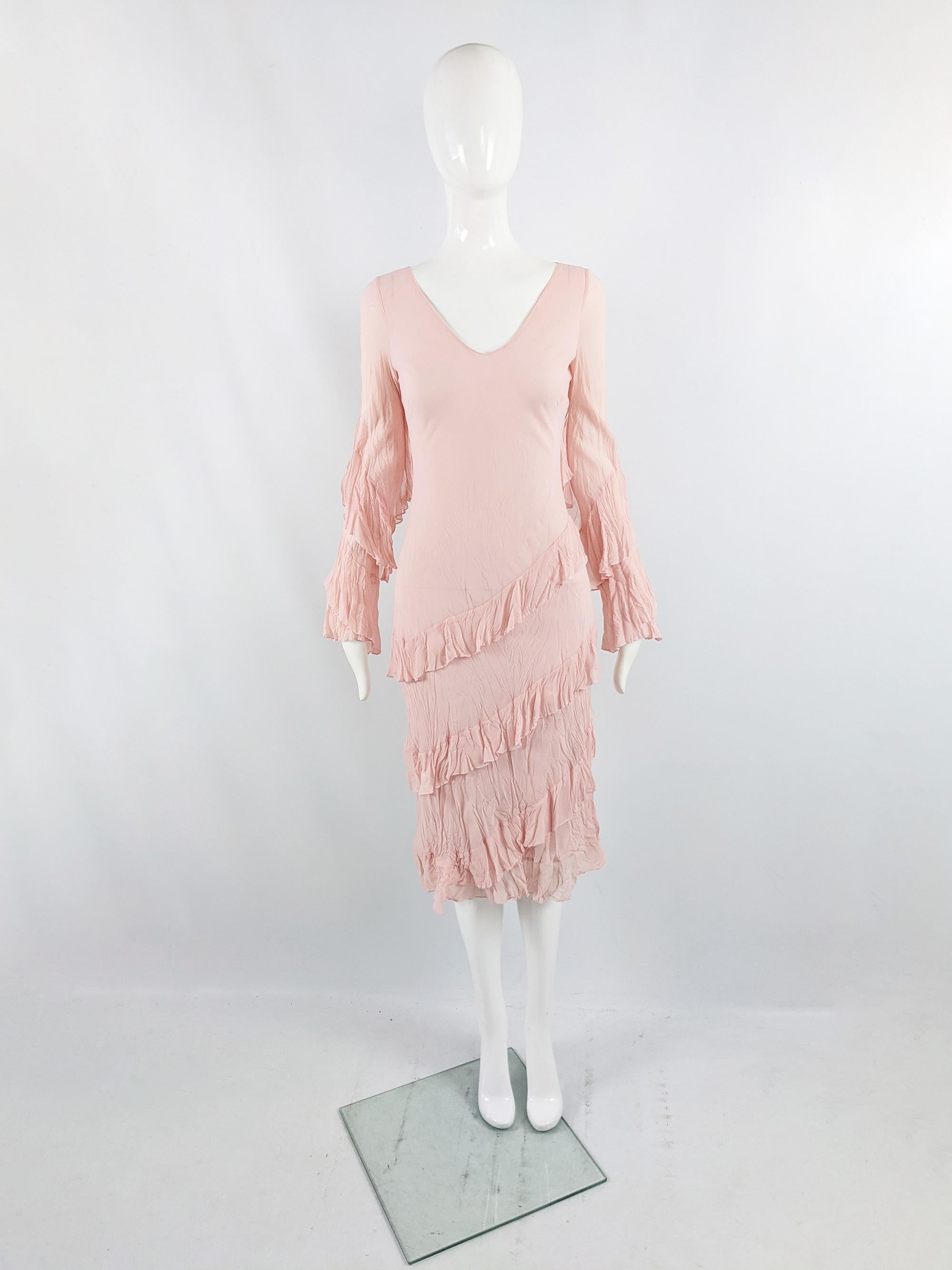A super cute vintage womens dress from the late 90s / early 2000s by Parisian designer label, Angel Nina. In a pastel pink crinkled fabric with ruffled tiers on the sleeves and hem. Perfect for the day or dressed up at a party in the evening.

Size: