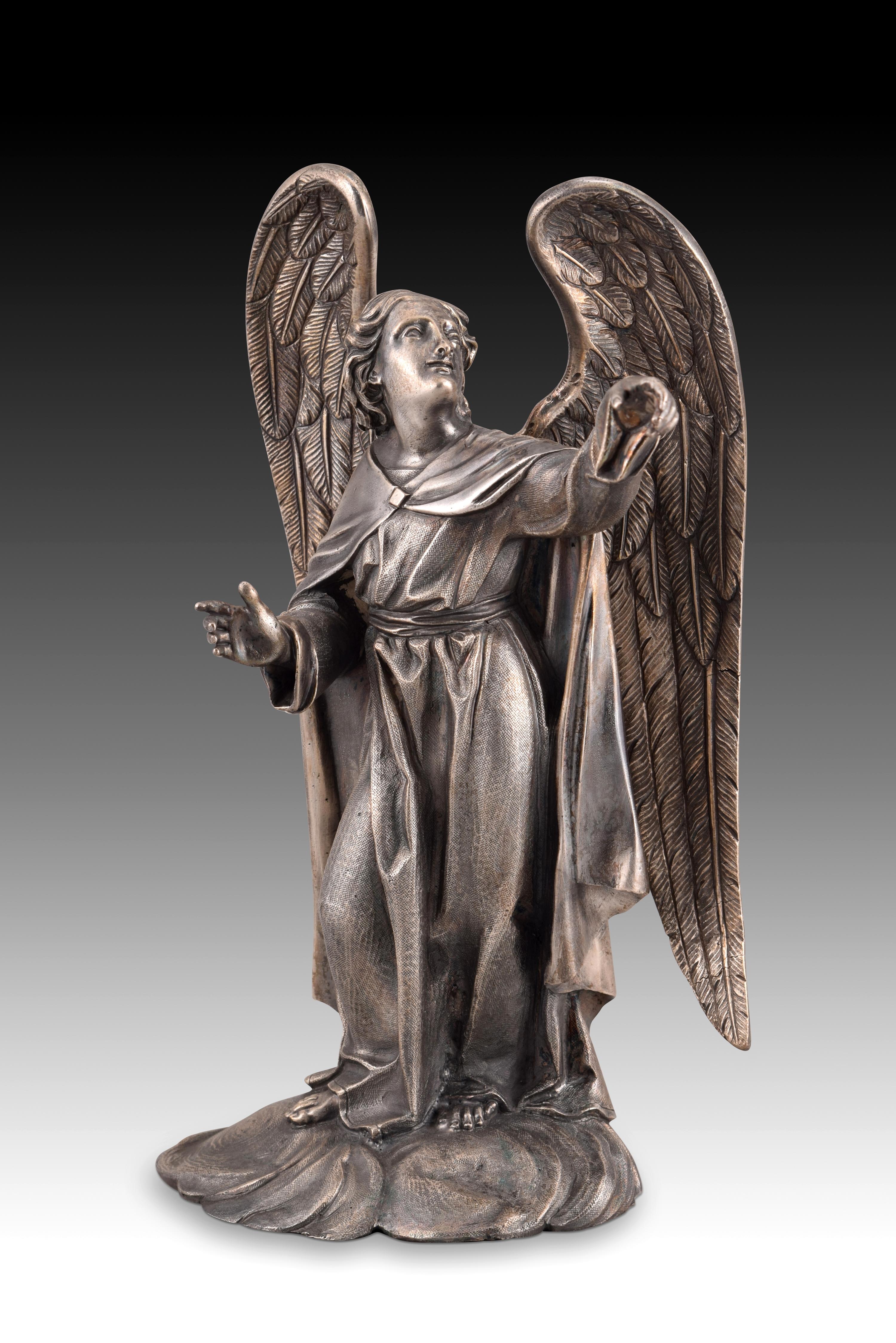 Angel. Metal in silver finish. XIX century. 
Angel or archangel figure made of silver metal, and standing on a base that resembles clouds. These types of sculptures were common in the 19th century both for churches and for personal altars, alone