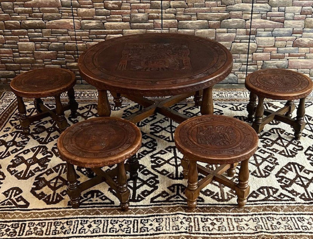 Set of South American midcentury coffee table with 4 stools designed by Ecuadorian designer, Angel Pazmino, circa 1960s, Ecuador. This set is made of solid tropical hardwood and thick carved tooled saddle leather that is embossed with Mayan