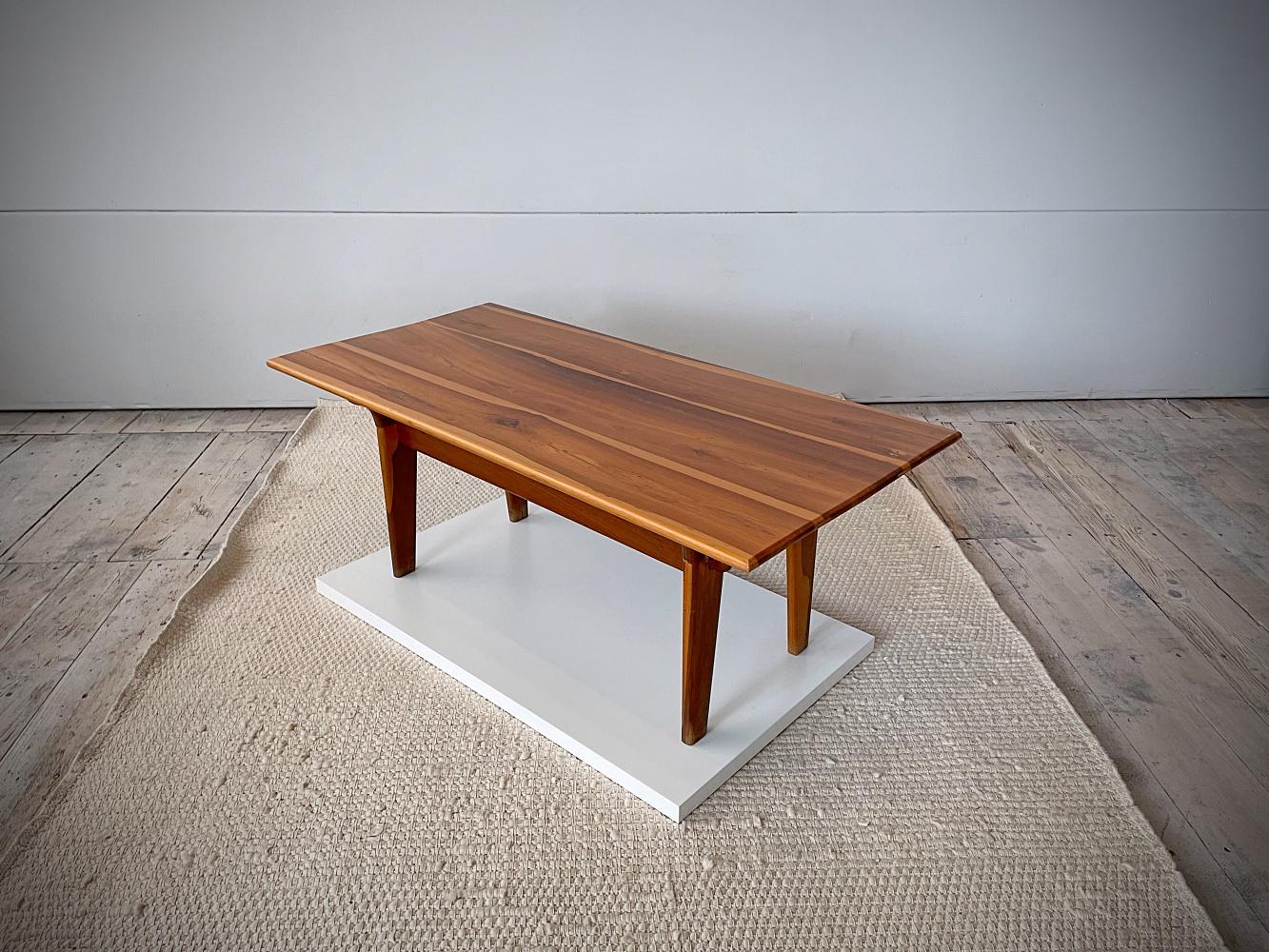 Beautiful sculptural couch table designed in 1960s by Angel Pazmino and manufactured by Muebles De Estilo in Ecuador. Constructed of solid rosewood using pegs and fitting together with the top and base as separate pieces. Angel studied the designs