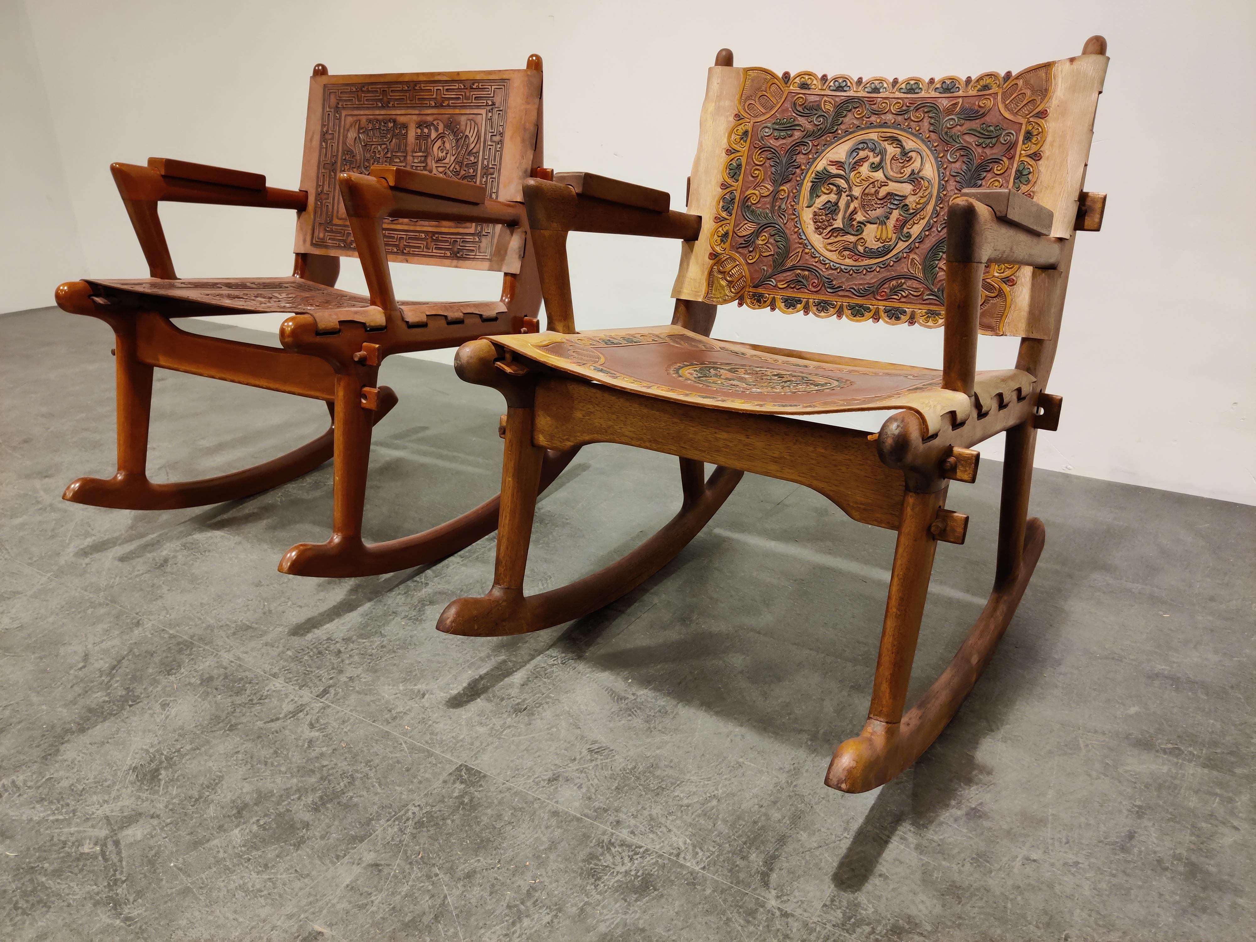 Midcentury wood and leather rocking chair designed by Angel Pazmino for Meubles De Estilo Ecuador. 

The chair features a wooden-peg frame with thick sculpted sling leather seats and backrests.

Beautiful midcentury piece with period correct