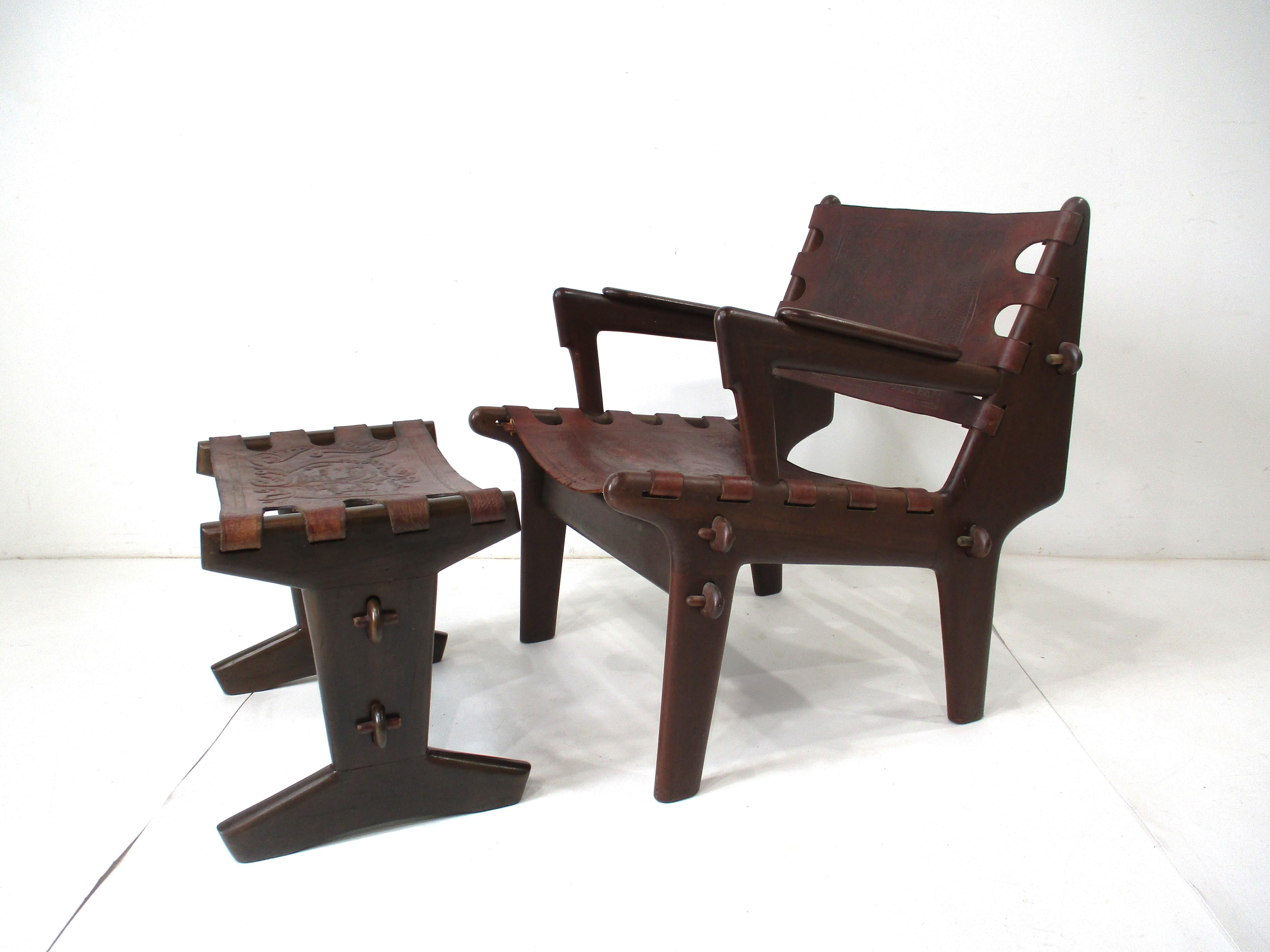 A handcrafted lounge chair and ottoman by famed designer and craftsman Ecuadoran Angel Pazmino made during the height of the 1960s Mid-Century Modern movement in South America. Made of solid rosewood using pegs and fitting together like an