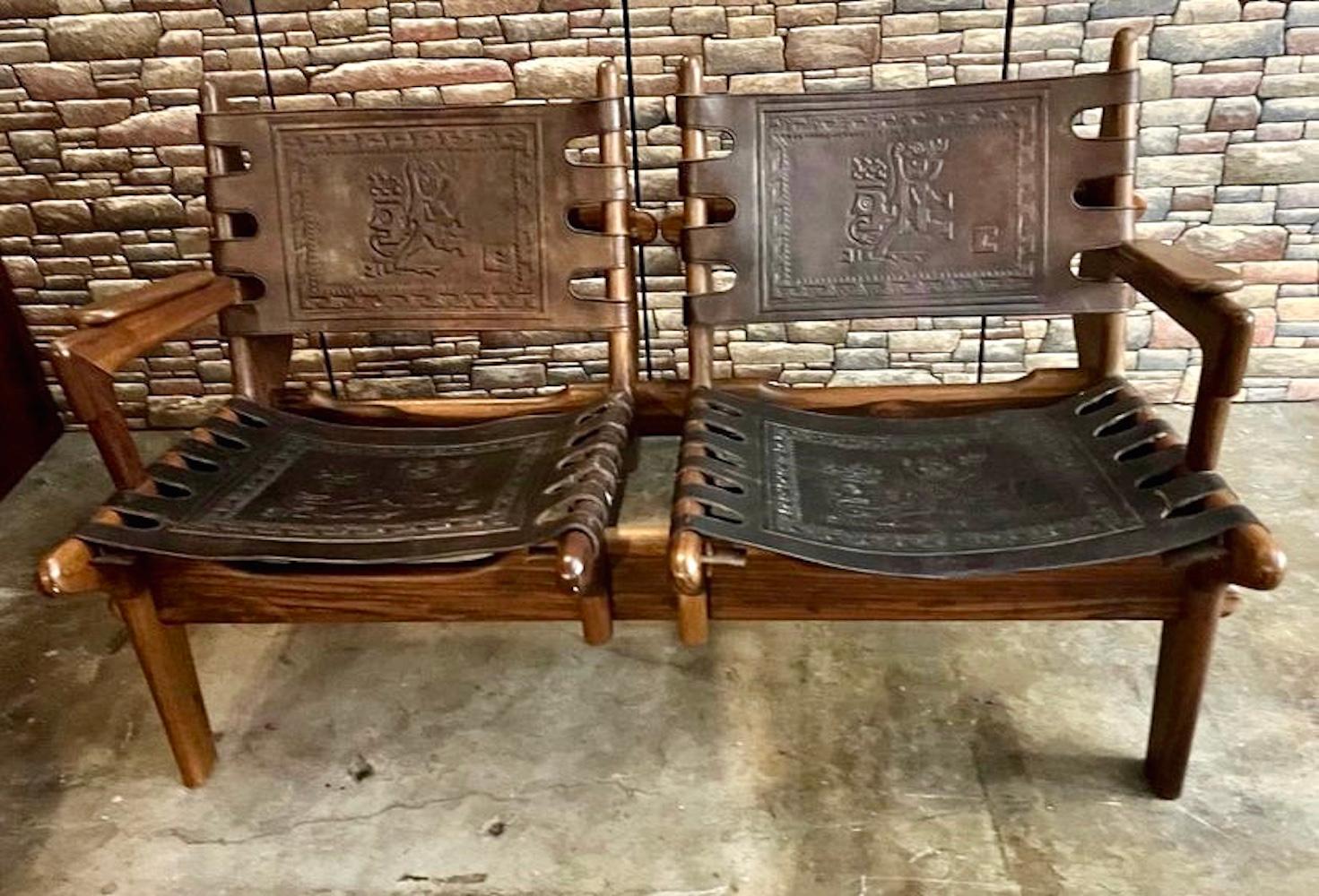 Amazing set of South American midcentury rocker and loveseat designed by Ecuadorian designer, Angel Pazmino, circa 1960s, Ecuador. This set is made of solid tropical hardwood peg-jointed and thick carved tooled saddle leather that is embossed with
