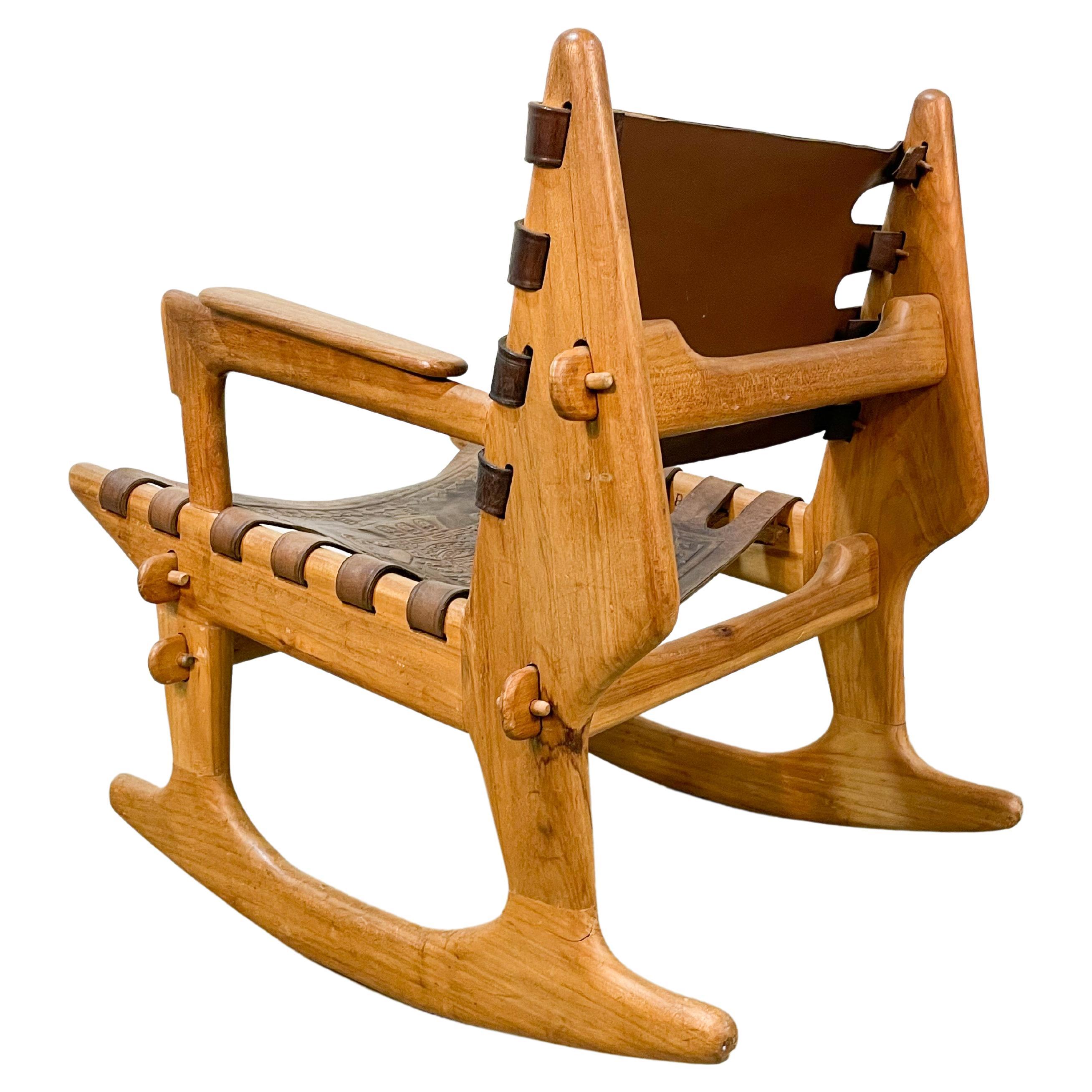 Unique organic modern form rocking chair designed by Angel Pazmino and made by Muebles de Estilo in Quito, Ecuador, in the 1960s. Interlocking frames of solid Laurelwood held together by simple pegs provide a constructivist quality and the
