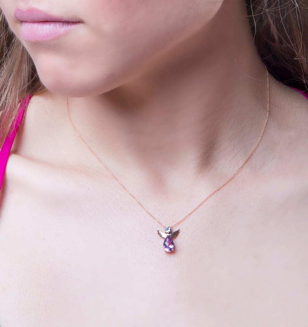 Guardian Angel Pendant Necklace 18kt Rose Gold with Blue Round Aquamarine and Purple Pear Amethyst.
The angel is made of 18Kt rose gold, blue aquamarine and purple amethyst. It comes with an 18Kt rose rolo chain, 16 inches long. The pendant necklace