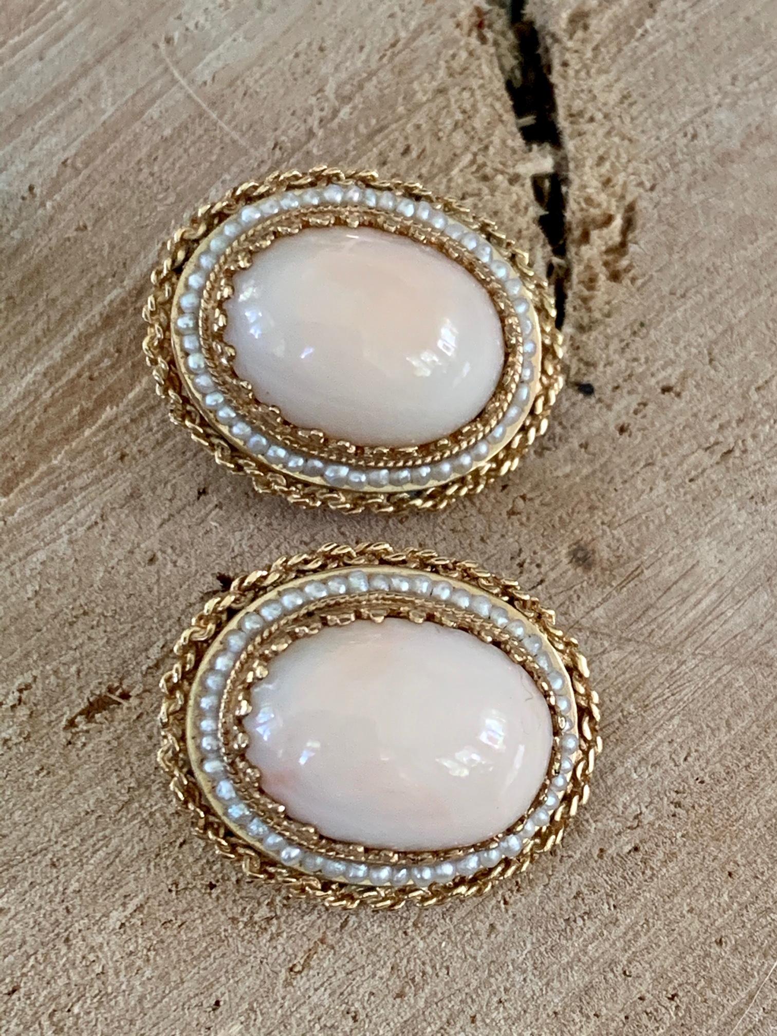Fabulous vintage Angel Skin coral clip-on earrings are set in 14k gold with a seed pearl halo.
They are stamped 14k.
The oval Angel Skin Coral Cabochon stone size is 18 x 14 mm.
The earrings measure 1 1/8