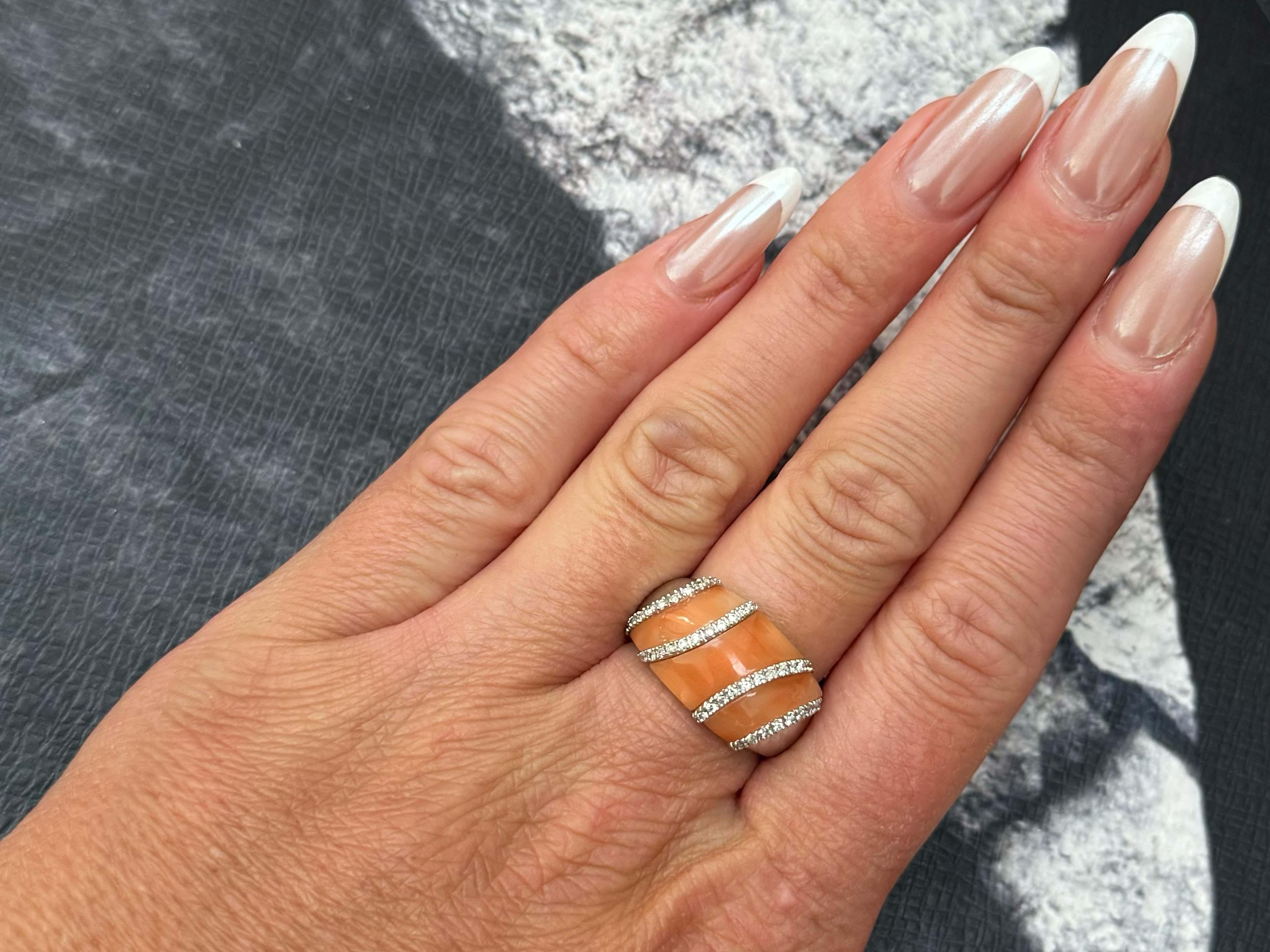 Item Specifications:

Metal: 14K White Gold

Style: Statement Ring

Ring Size: 7 (resizing available for a fee)

Total Weight: 5.8 Grams
​
​Gemstone: Angelskin Coral

Ring Height: 12.5 mm

Diamond Count: 40 round brilliant cut 

Diamond Color: