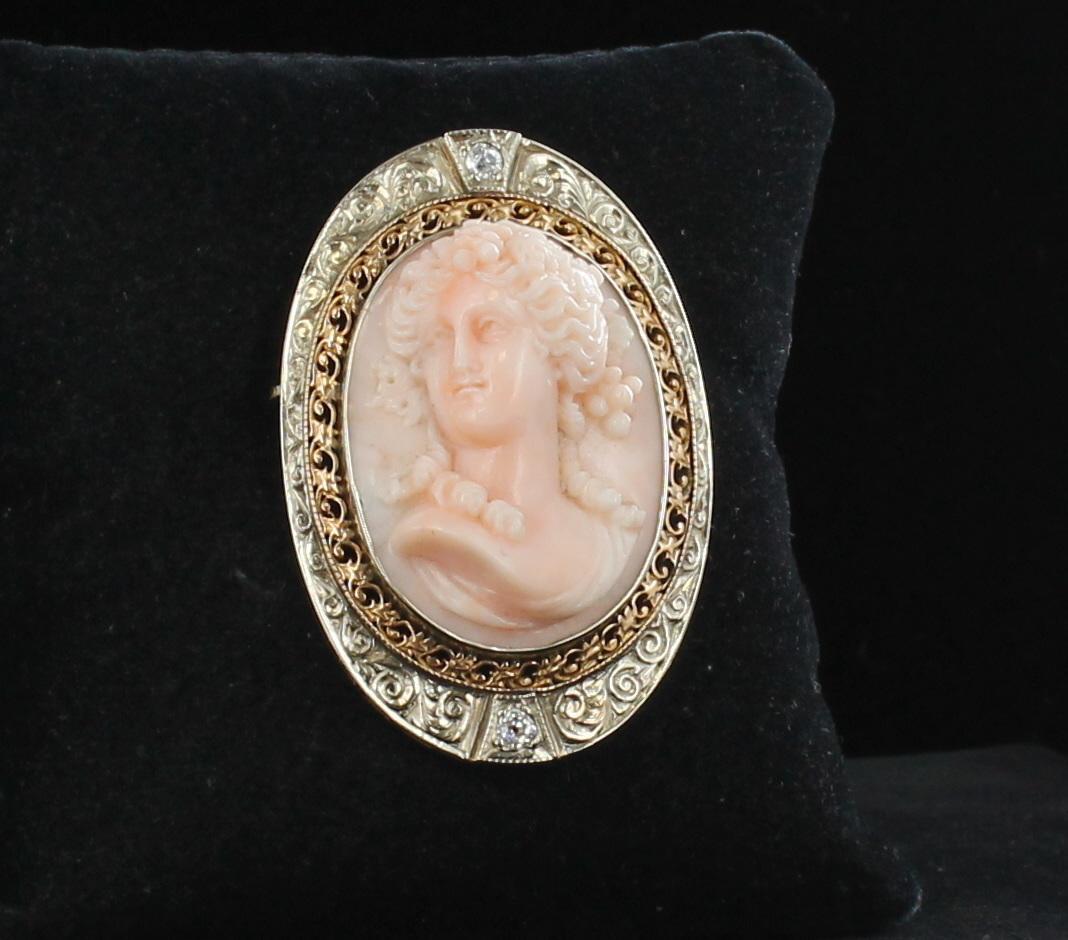 This impressive oval hand-carved angel skin cameo is magnificent in its attention to detail.  Created in the early 1900's, the lovely lady appears to be displayed in a double frame.  It is first surrounded by 14 karat yellow gold filagree which has
