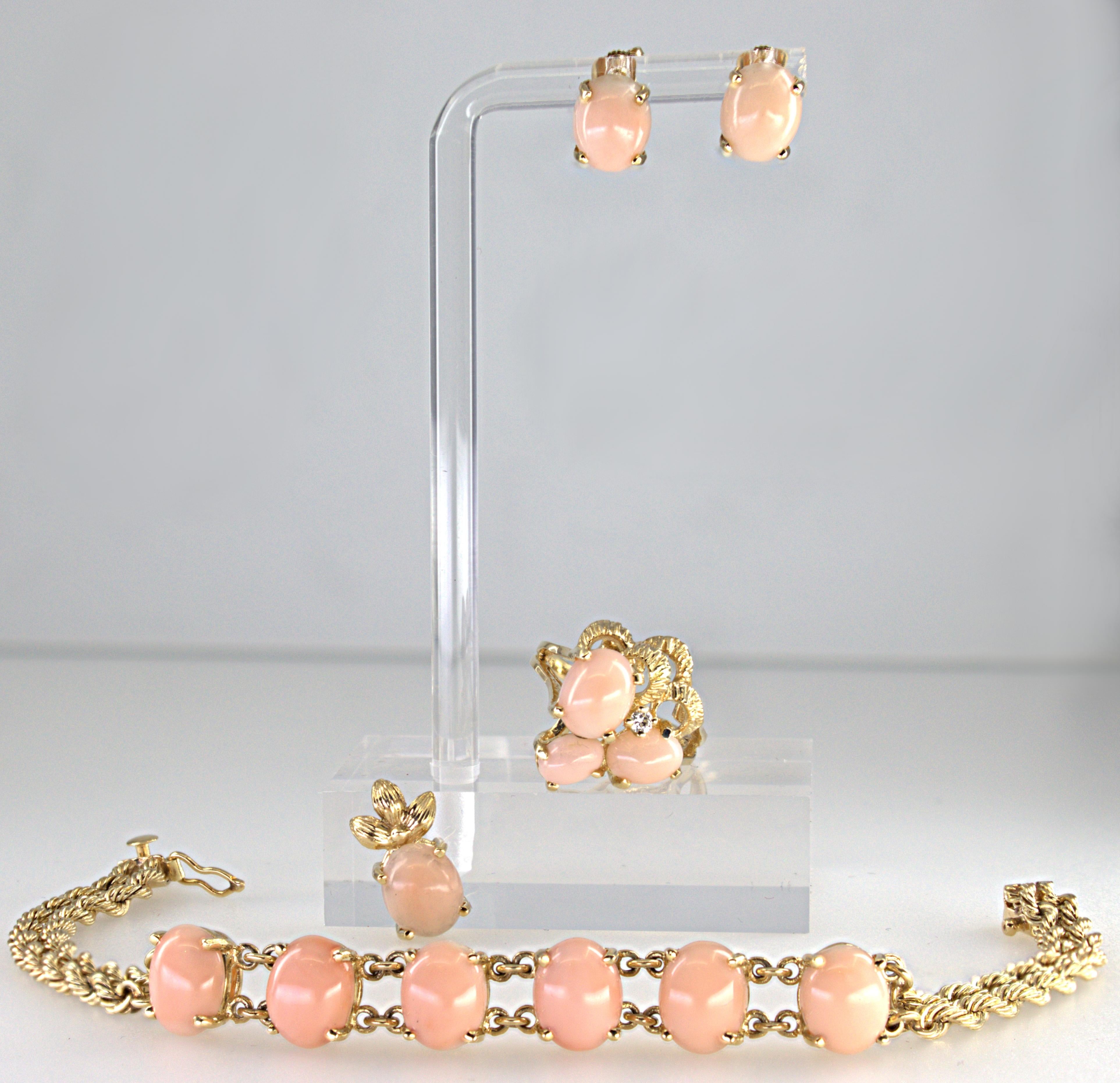 Including one bracelet; featuring (6) oval light pink angel skin coral cabochons, 10 X 7.9 X 4 mm, set and linked in 14k yellow gold, attached to a double 14k yellow gold rope link chain, completed by a box clasp with figure eight safety, forming 7