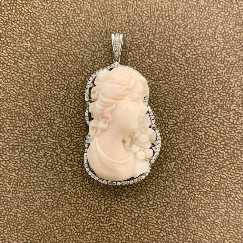 With a soft pink hue this coral cameo gets the trade name “angel skin” to describe its pleasant color. The cameo is bordered by 1 carat of round brilliant cut diamonds which are set in 18k white gold.

A cameo of a lovely lady for another lovely