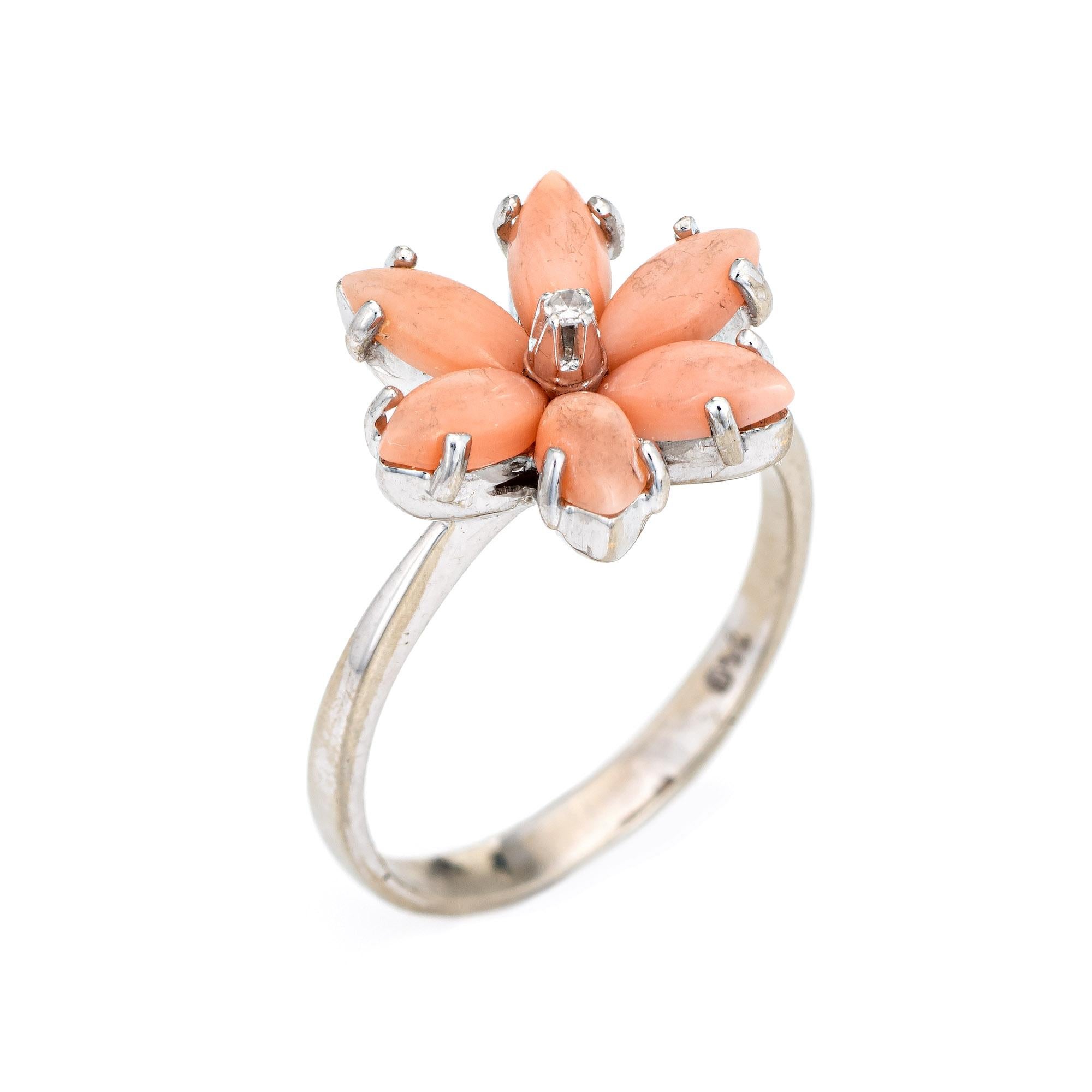 Stylish angel skin coral flower cocktail ring crafted in 18 karat white gold. 

Cabochon cut coral measures 6mm x 3mm (estimated at 0.25 carats each - 1.50 carats total estimated weight). One estimated 0.01 carat (estimated at H-I color and SI1