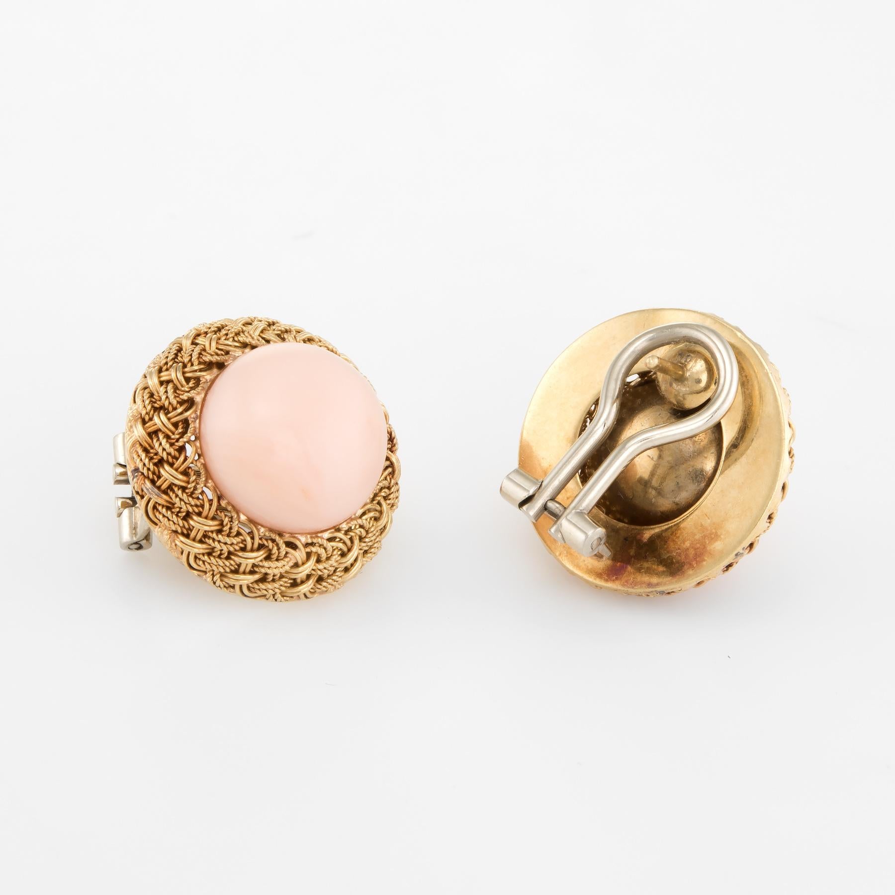 Elegant pair of vintage angel skin coral earrings (circa 1950s to 1960s), crafted in 18k yellow gold. 

Round cabochon cut angel skin coral measures 13mm each (estimated at 10 carats each - 20 carats total estimated weight). The coral is in