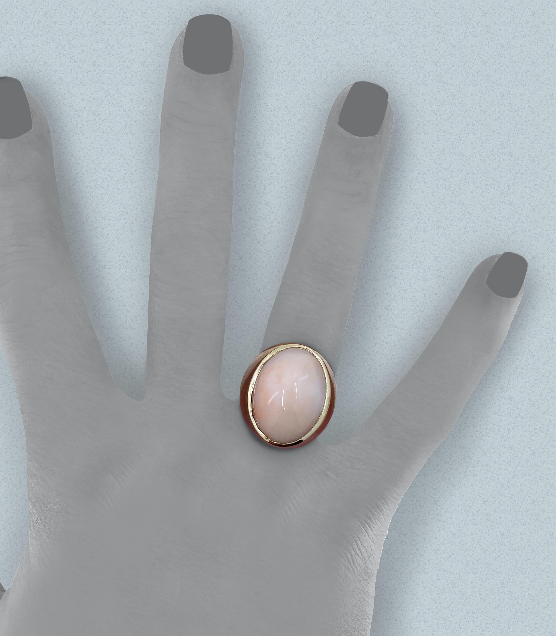 This eye-catching solitaire, probably produced in the 1960s or 1970s,  makes a bold statement, contrasting the delicate light peachy-pink (or is it pinky-peach?) of angel skin coral and the muscular signet-ring setting.  

The natural, very light