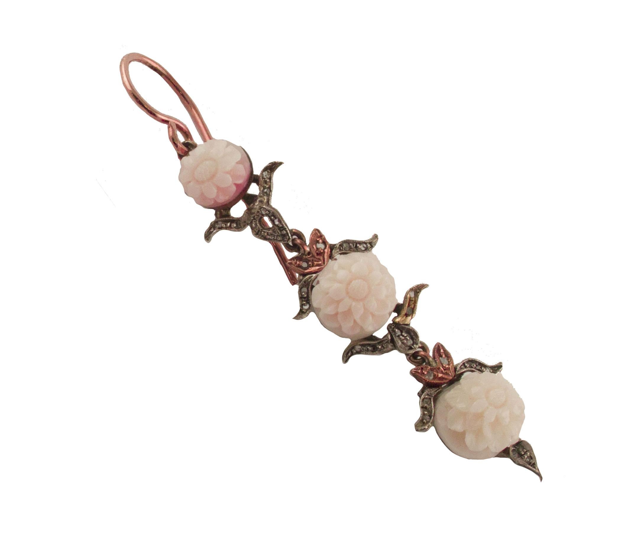 Beautiful handmade pendant earrings, (6.4 / 7.10 cm length), made in 9 kt rose gold and silver, enriched with gold and silver leaves detailes and small elegant and refined flowers engraved on a 5.40 g  angel skin pink coral and decorated with 0.23