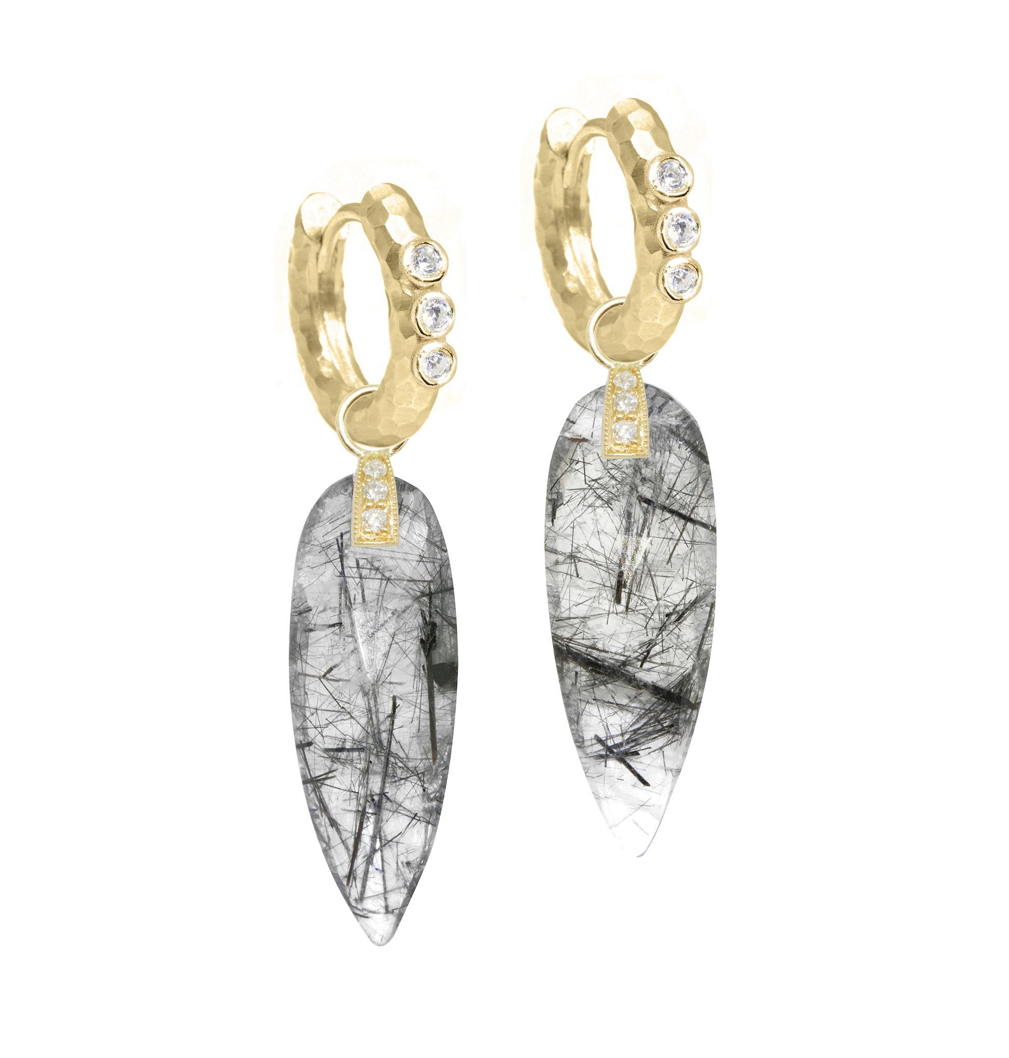 Subtle, luminous color and a graphic, geometric shape: the Angel Wings 30mm Gold Charms make a statement with black tourmalated quartz drops dangling from a diamond-studded bale.


Nina Wynn Design's patent-pending earrings have an element on the