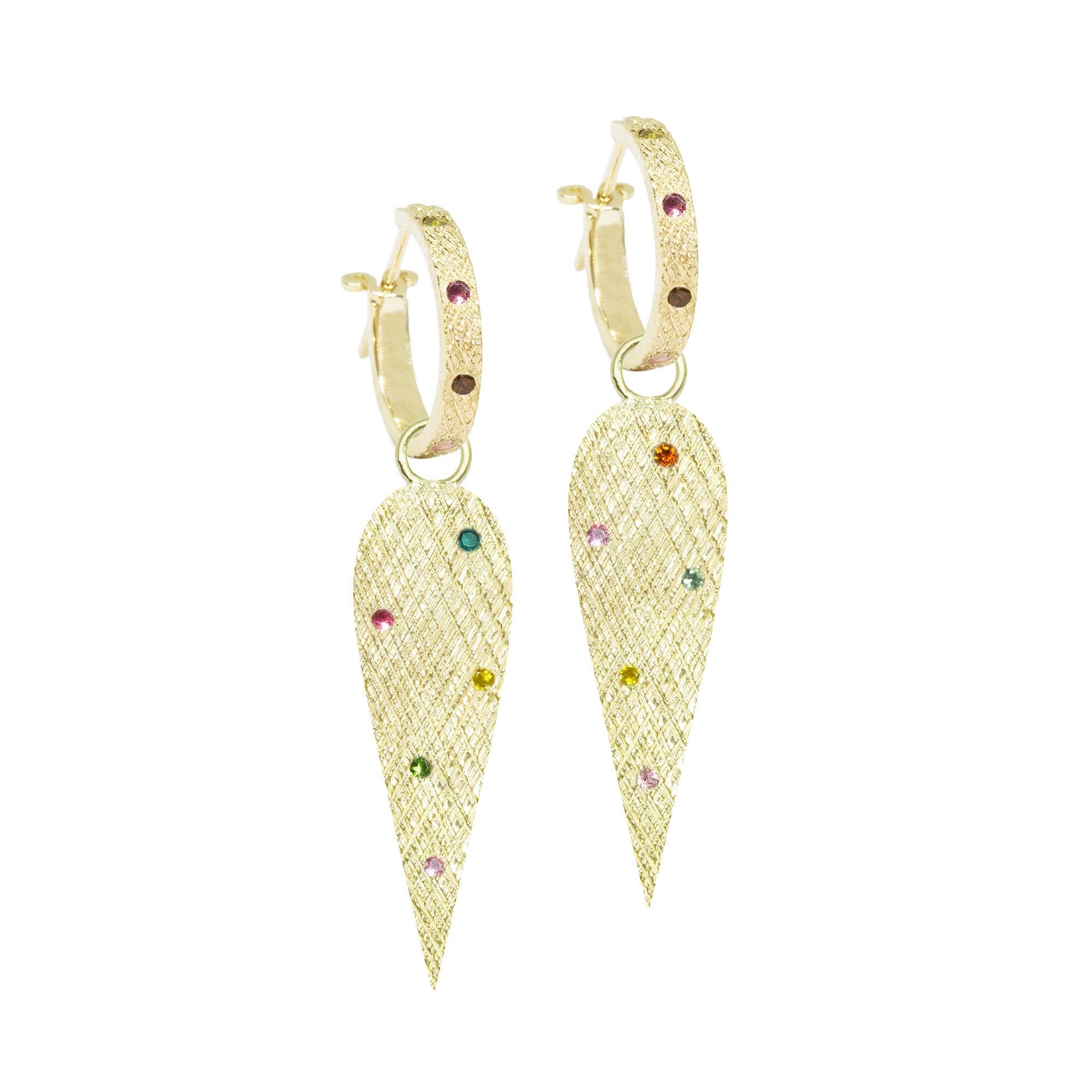 The perfect everyday style, especially when you want a subtle pop of color, the Angel Wings 30mm Gold Charms scatter tourmalines on a rich gold background detailed with a feather-like crosshatch pattern.
Nina Nguyen Design's patent-pending earrings