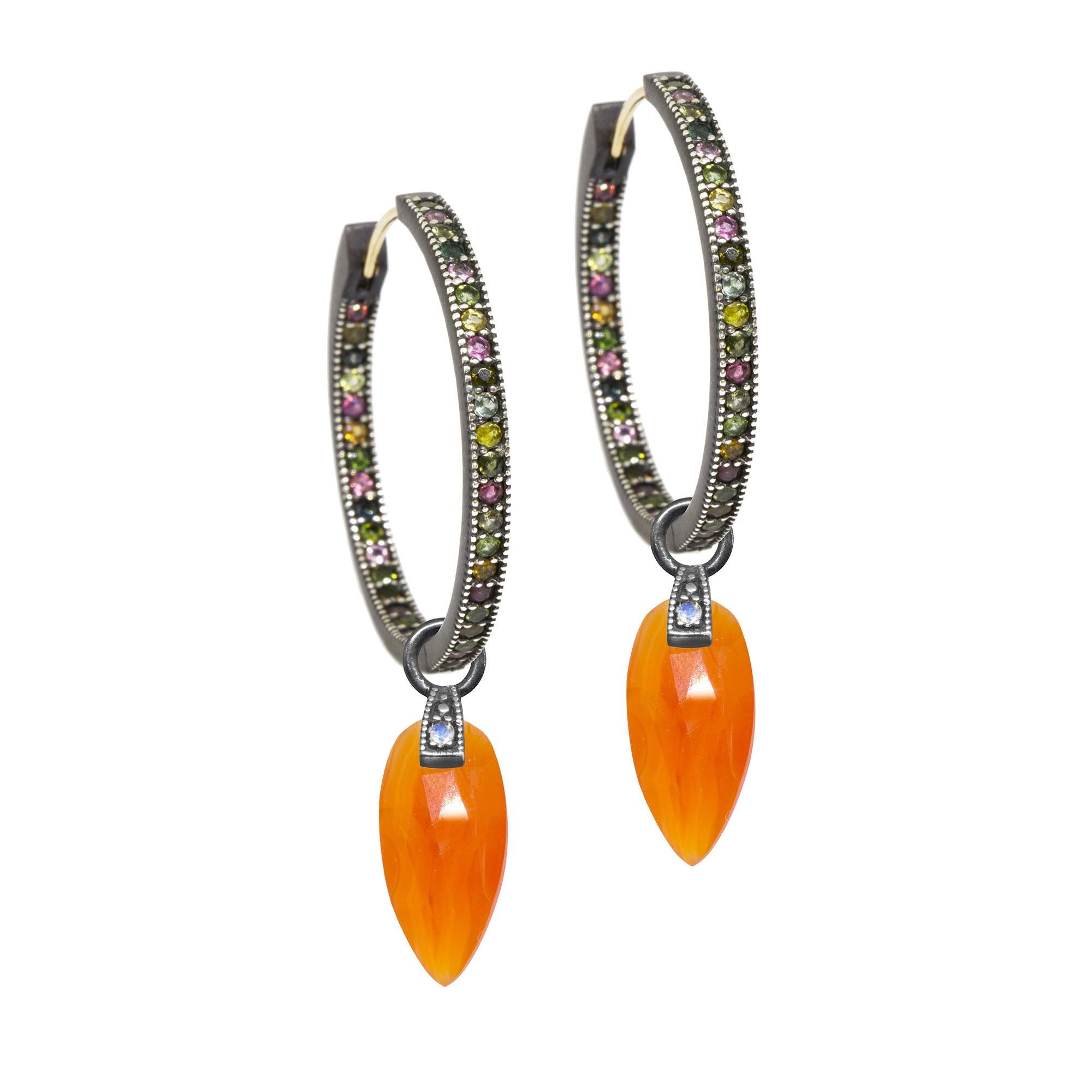 The perfect everyday style, especially when you want a pop of juicy orange, the Angel Wings 15mm Oxidized Charms feature milky carnelian drops dangling from a gemstone-studded bale.

Nina Nguyen Design's patent-pending earrings have an element on