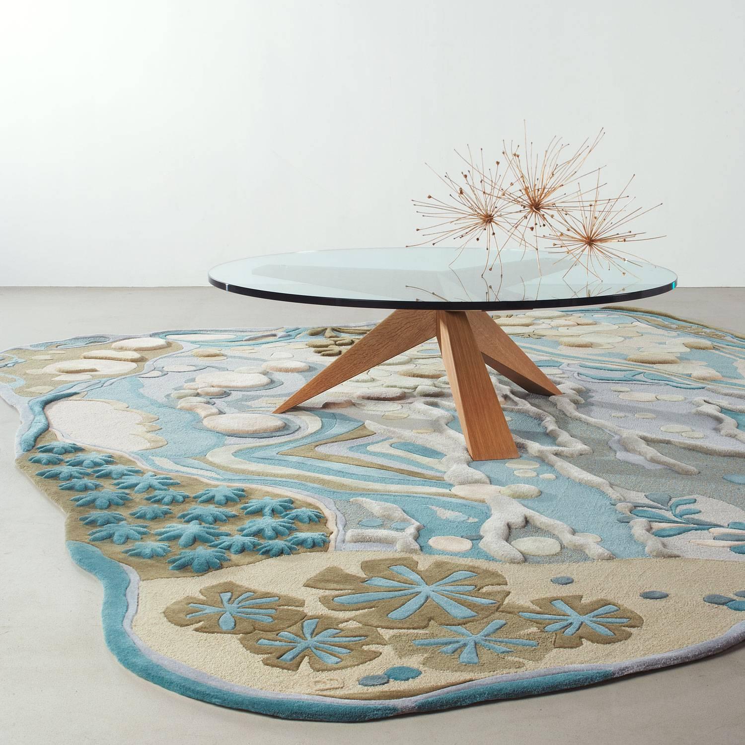 The Angela Adams Dune area rug is an organic, free-form, coastal design inspired by the abundant beauty of nature found along the ocean's edge. Sand dollars, beach rocks, mussel shells, starfish and seaweed inhabit the sand, saltwater and surf.