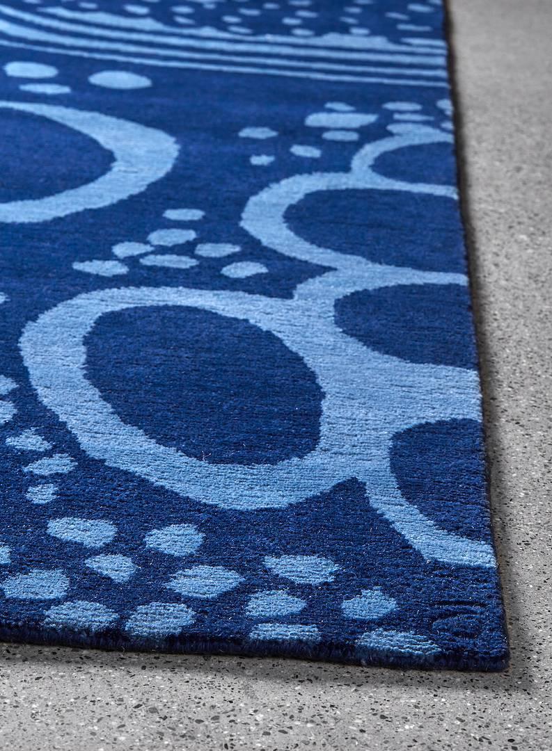 The Angela Adams glacier / blue area rug features a frozen landscape that celebrates the evolving and transformative quality of its namesake. At the same time energetic and calm, this design depicts once flowing rivers, round rocks, and circular air
