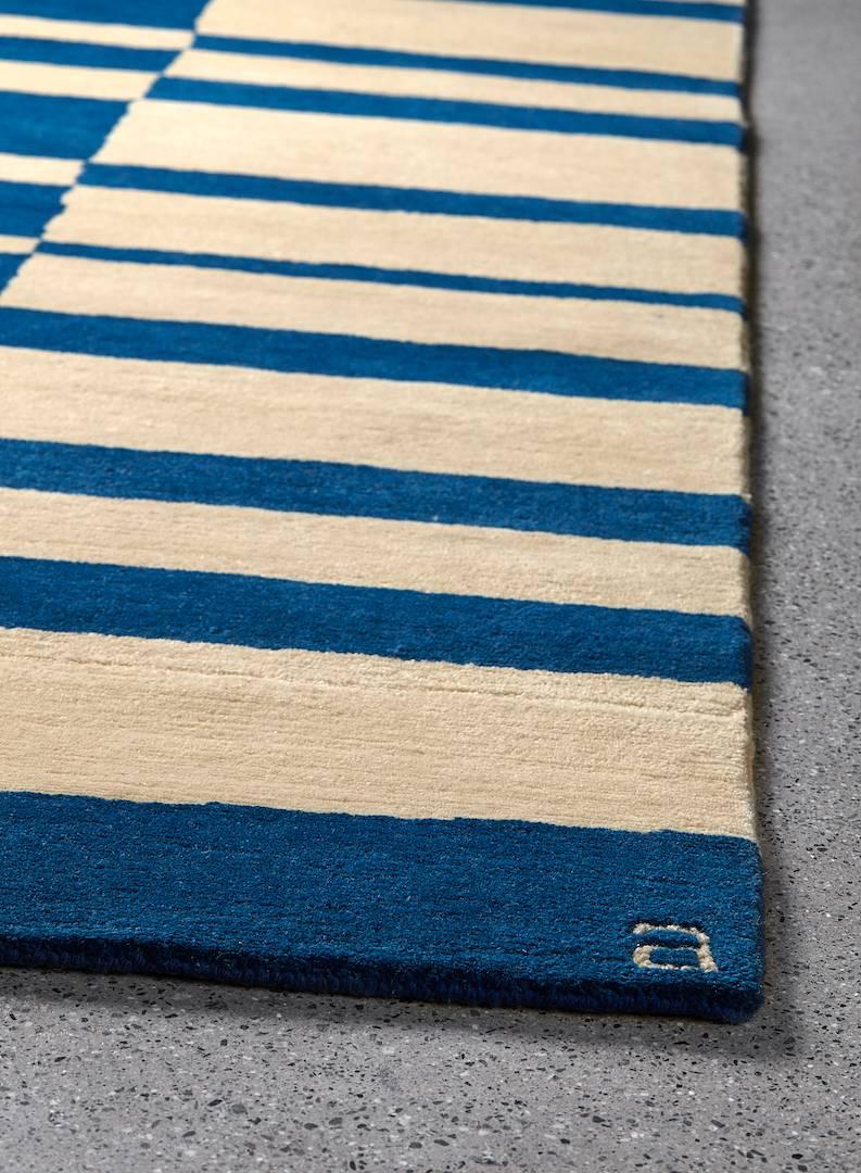 The Angela Adams Mack / Azure design is an exploration of positive and negative space, with linear and free form lines and shapes in bright blue and natural. Hand-knotted with 100% New Zealand wool, every Angela Adams area rug is ethically and
