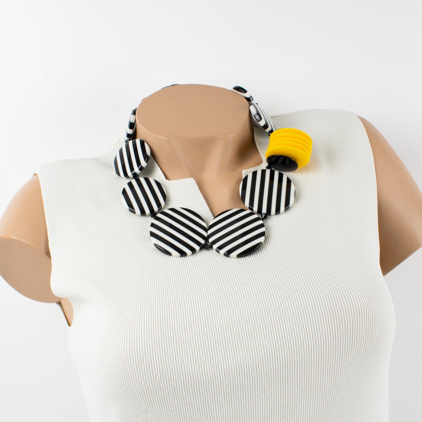 This lovely Angela Caputi, made in Italy choker necklace features an unusual color pattern. The choker is built with large flat disks in a black and white striped texture pattern and is contrasted with dimensional raised bright yellow flat disks.