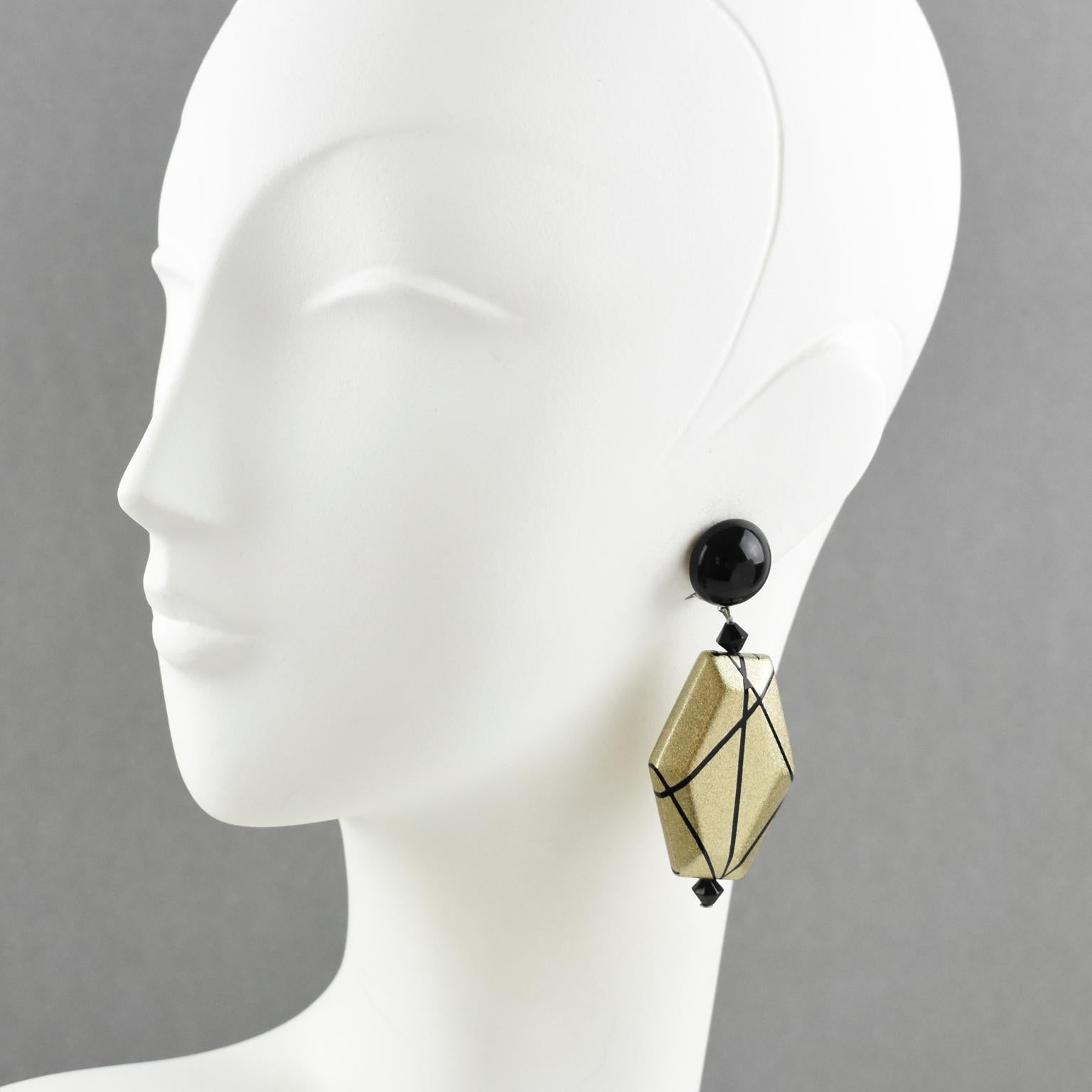 Stunning Angela Caputi, made in Italy resin clip-on earrings. Dangling shape with black color contrasted with pale gold resin geometric pebble bead all wrapped around with black lines. 
As you know Caputi jewelry is not signed. This is a pre-owned
