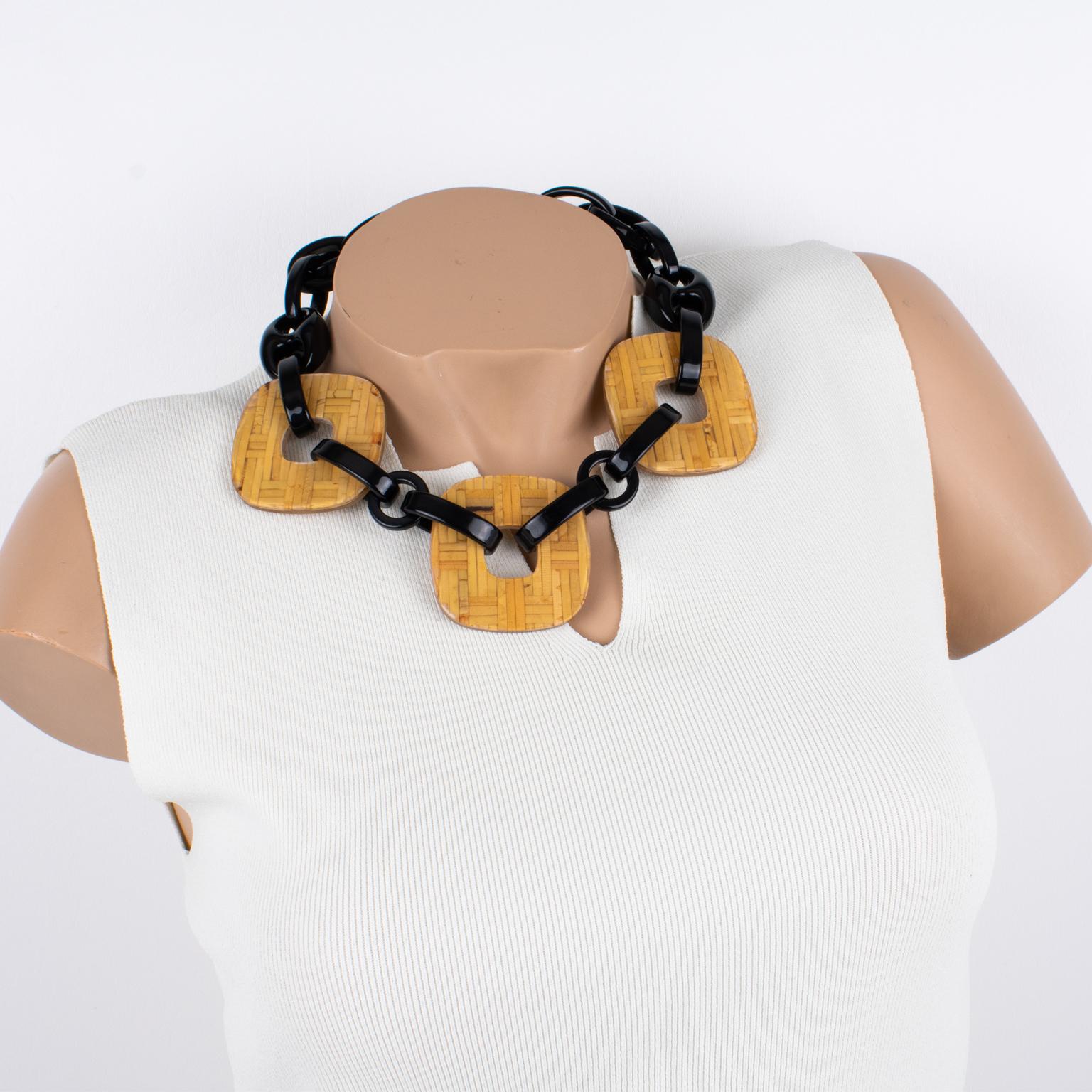 Angela Caputi designed this gorgeous made-in-Italy resin and Lucite choker necklace. The around-the-neck shape boasts black resin geometric elements contrasted with three flat square donuts in clear Lucite with embedded rattan or wicker. The piece