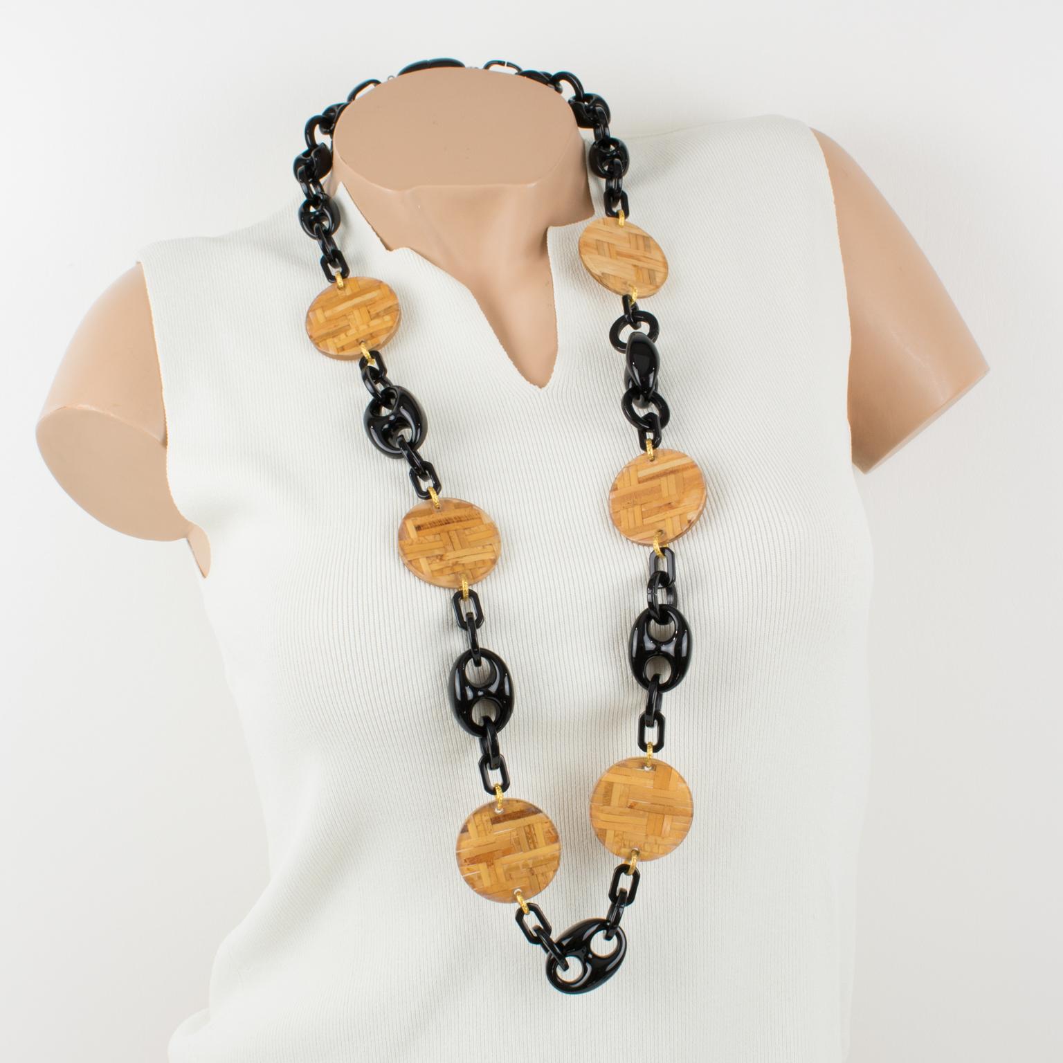 Stunning Angela Caputi, made in Italy resin and Lucite long necklace. Extra-long shape with black resin geometric elements contrasted with large flat disks in clear Lucite with embedded rattan or wicker. Brand signature snap-closing clasp. Her