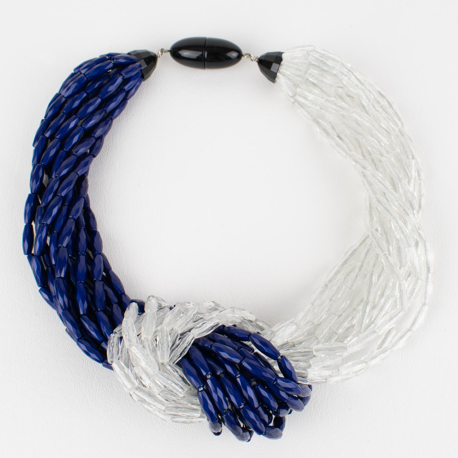 Angela Caputi, Italy, crafted this stunning resin choker necklace in the 1990s. The oversized multi-strand design features tiny oval resin seed beads, complemented by a large knot on the front. The choker boasts faceted beads in cobalt blue and