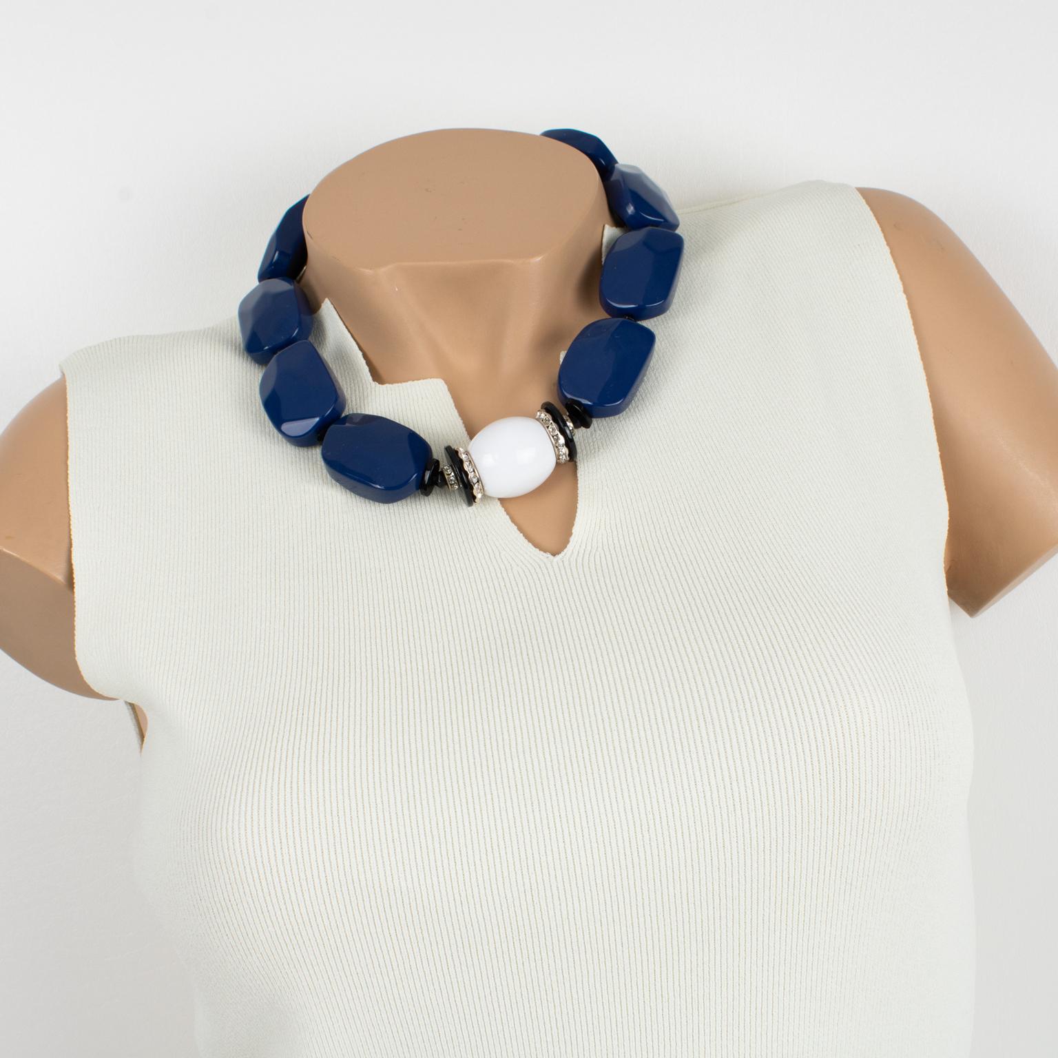 This elegant Angela Caputi, made-in-Italy resin choker necklace features chunky carved pebble beads with a central round domed bead with crystal rhinestones spacers and works on cobalt blue and white contrast. Her color matching is always extremely