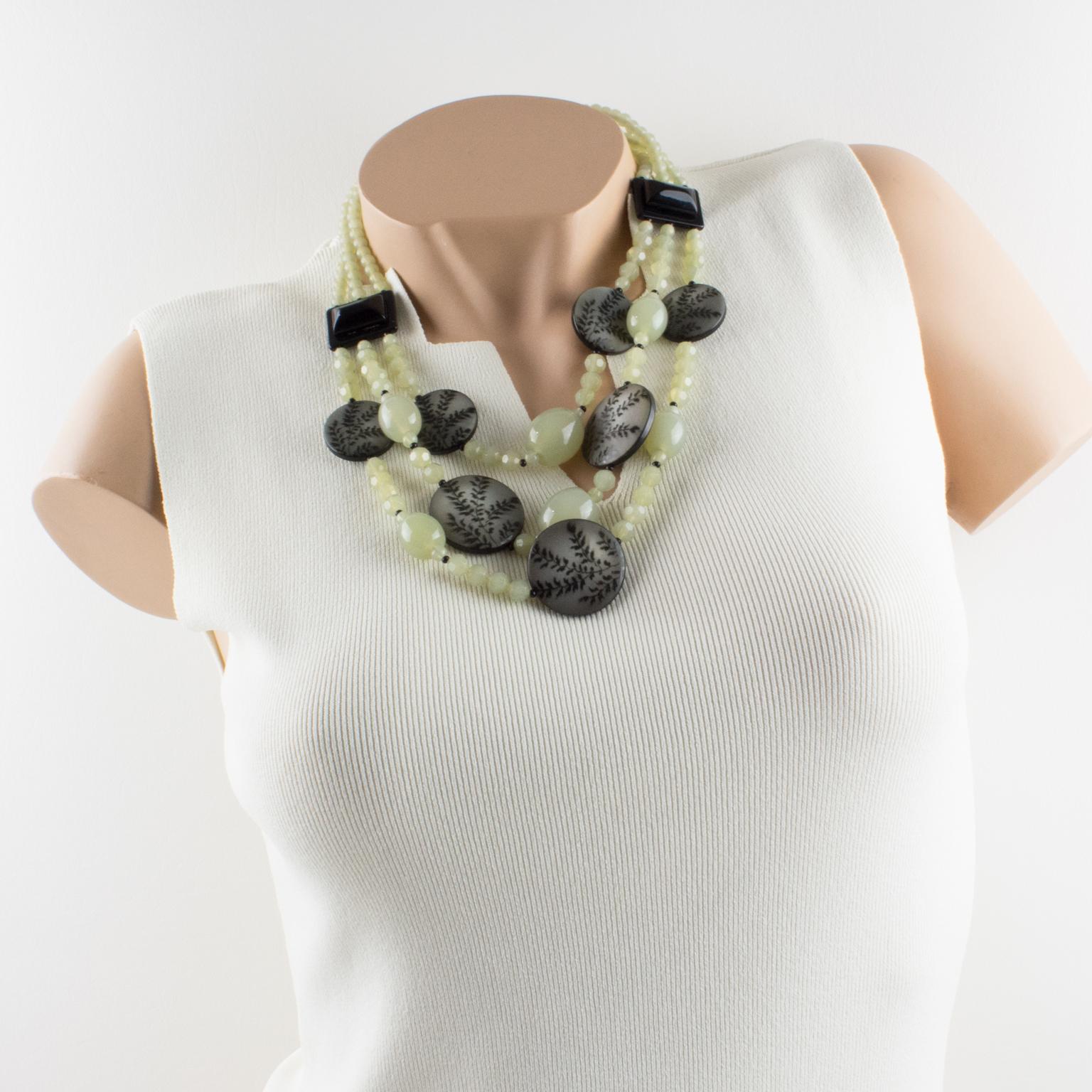 Refined Angela Caputi, made in Italy multi-strand cascading beaded choker necklace. Resin beads with three strands. Assorted color range with black and aqua green. The black dimensional disks have floral design engraving that worked like a photo