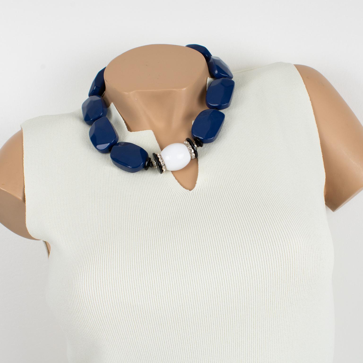 Elegant Angela Caputi, made in Italy resin choker necklace. 
This necklace features chunky carved pebble beads with a central round domed bead with crystal rhinestones spacers and works on cobalt blue and white contrast. Her matching of colors is