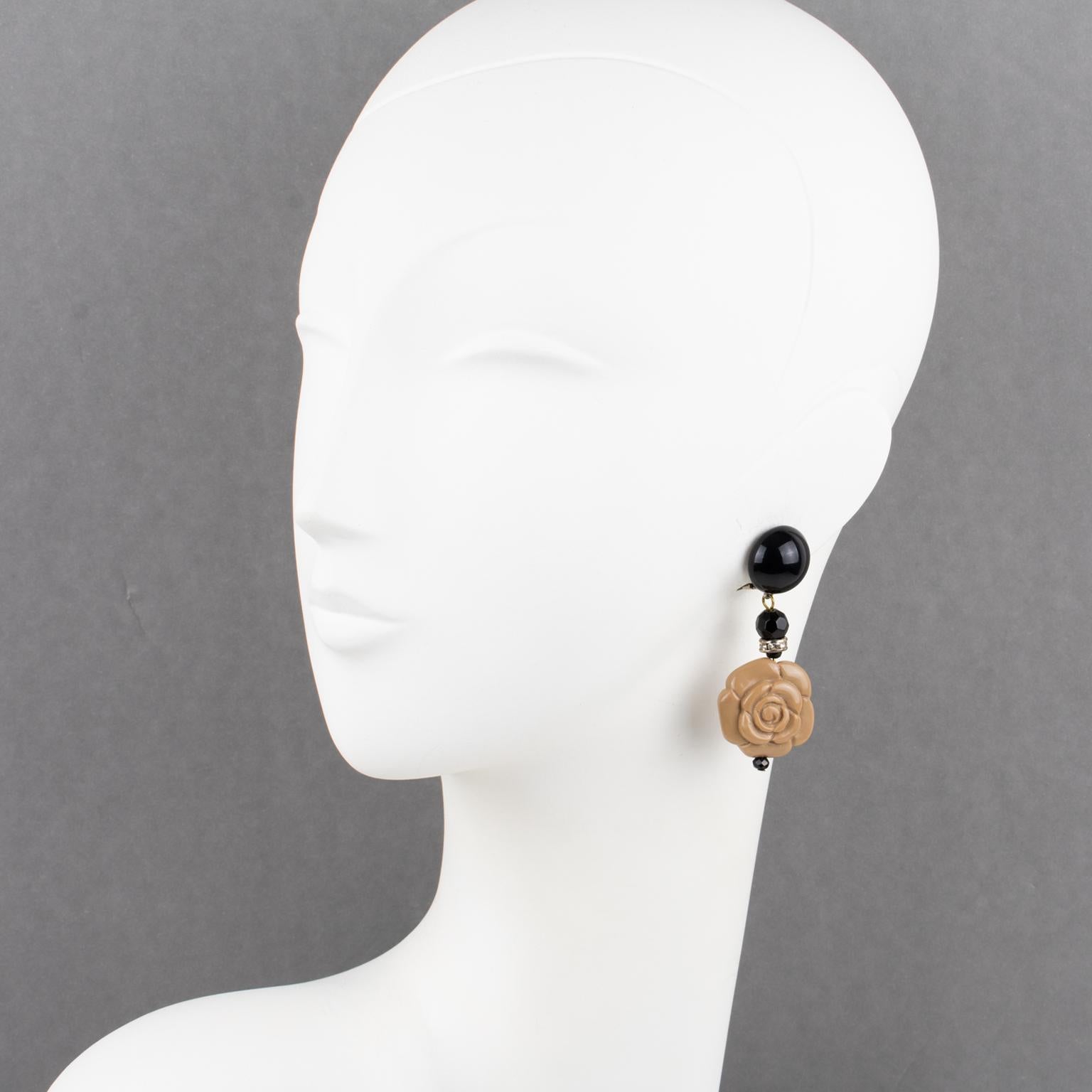 Charming resin clip-on earrings designed by Angela Caputi, made in Italy. Dangling shape with black color contrasted with a carved toffee beige resin floral element and complemented with tiny clear rhinestones spacer rings. 
As you know, Caputi