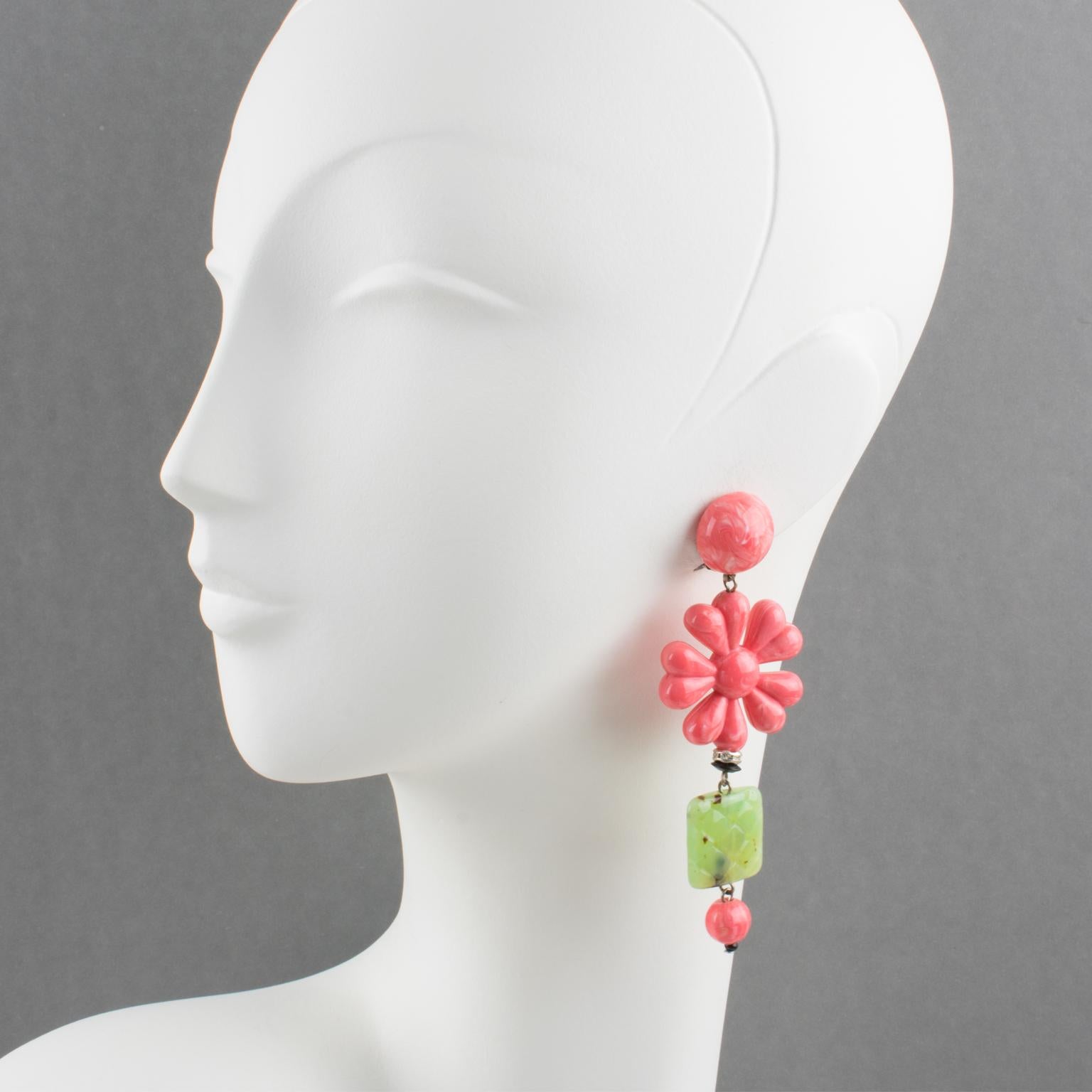 These amazing Angela Caputi, made in Italy resin clip-on earrings feature an oversized dangling shape with a dimensional stylized flower in faux coral color complimented with green faux-jade carved element and tiny crystal rhinestones ring spacer.