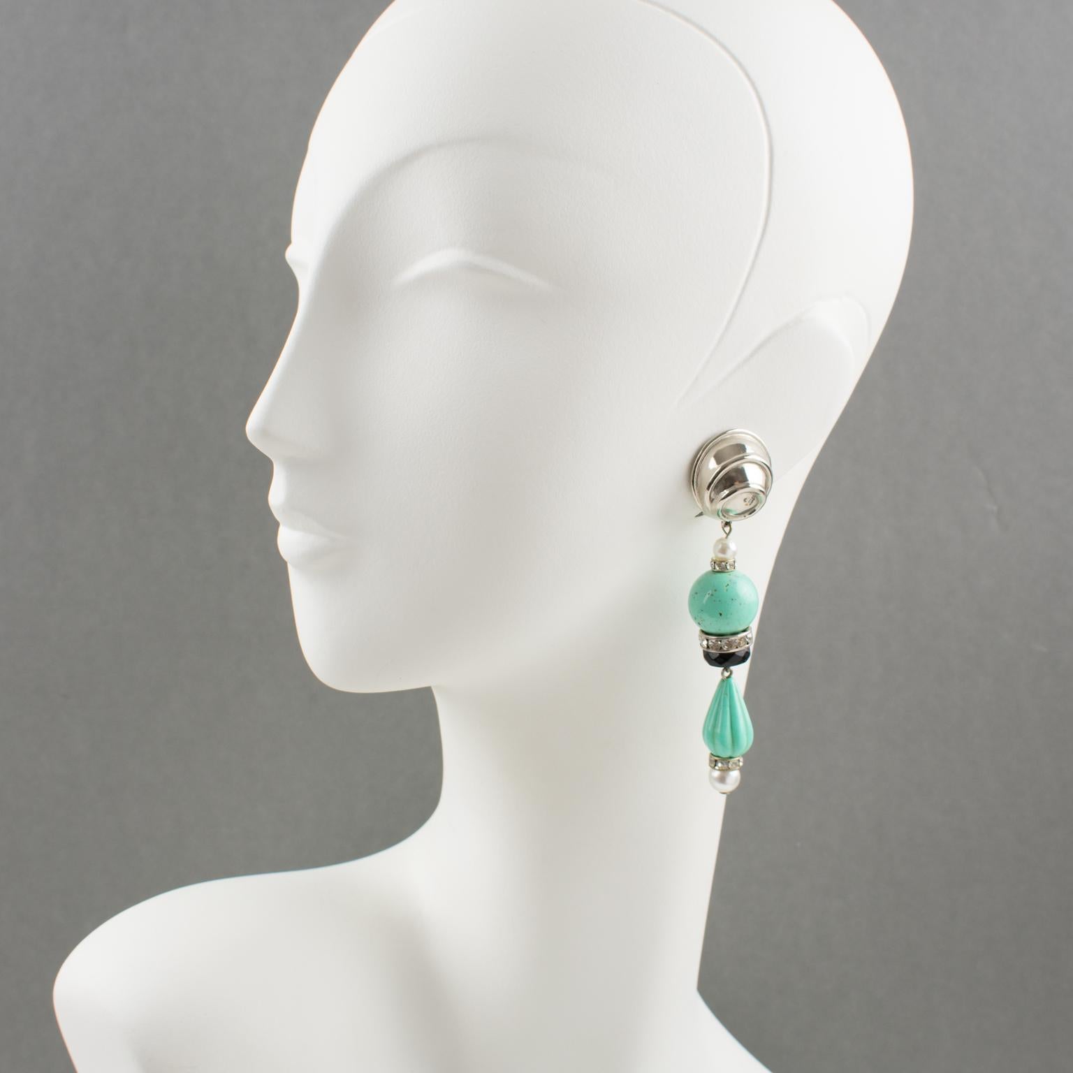 Stylish Angela Caputi, made in Italy resin and metal clip-on earrings. Dangling shape with simulated pearl and faux turquoise carved resin beads compliment with tiny rhinestones and black faceted rings and carved silvered metal fixtures. Her