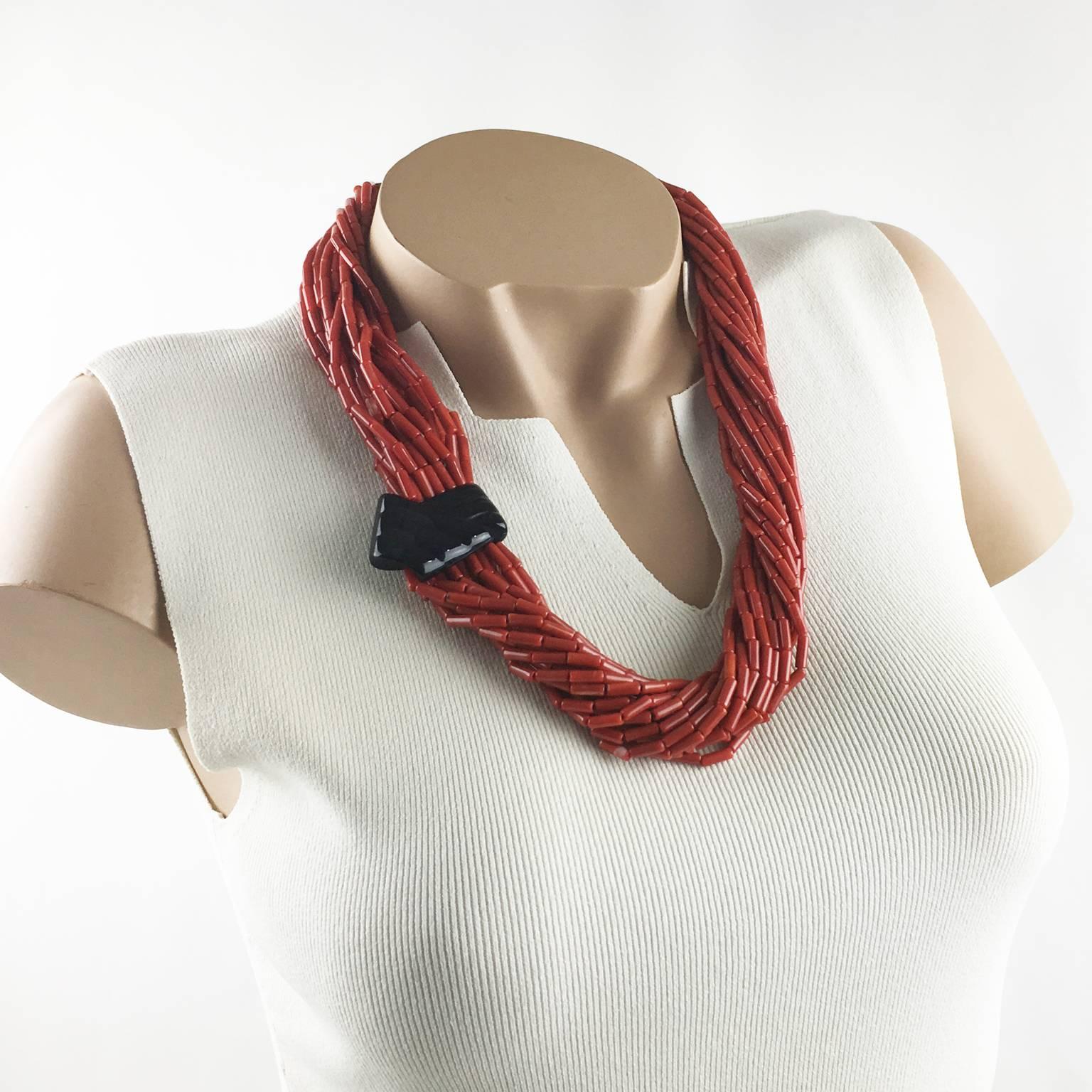 Lovely Angela Caputi, made in Italy resin choker beaded necklace. Oversized multi-strand design with tiny faux coral resin beads, compliment with a large black carved resin medallion. Her matching of colors is always extremely classy, perfect for