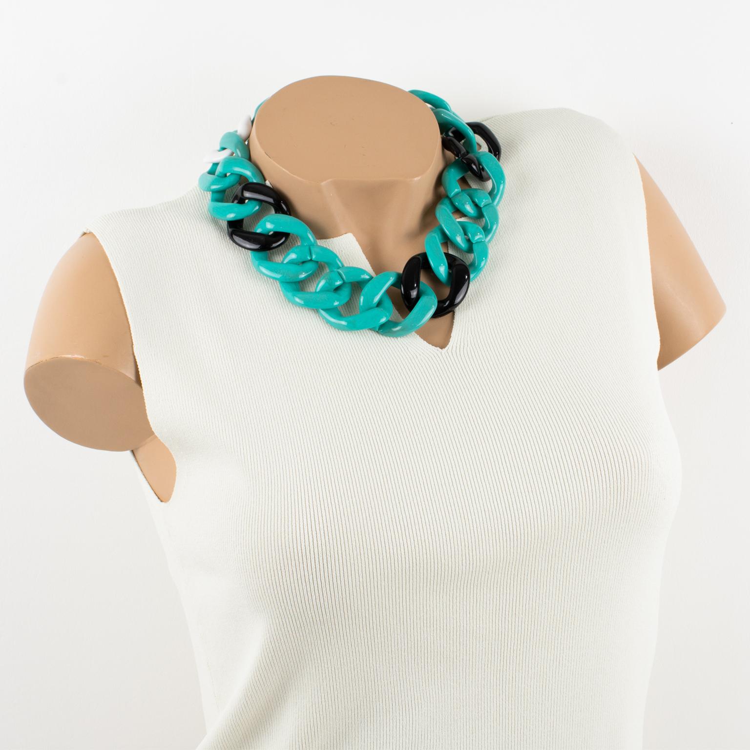 This adorable Angela Caputi, made-in-It Italy choker necklace features an extra-large flat resin chain design in turquoise-blue color with a black and white contrast. Her matching of colors is always bold and classy.
As you know, Caputi jewelry is