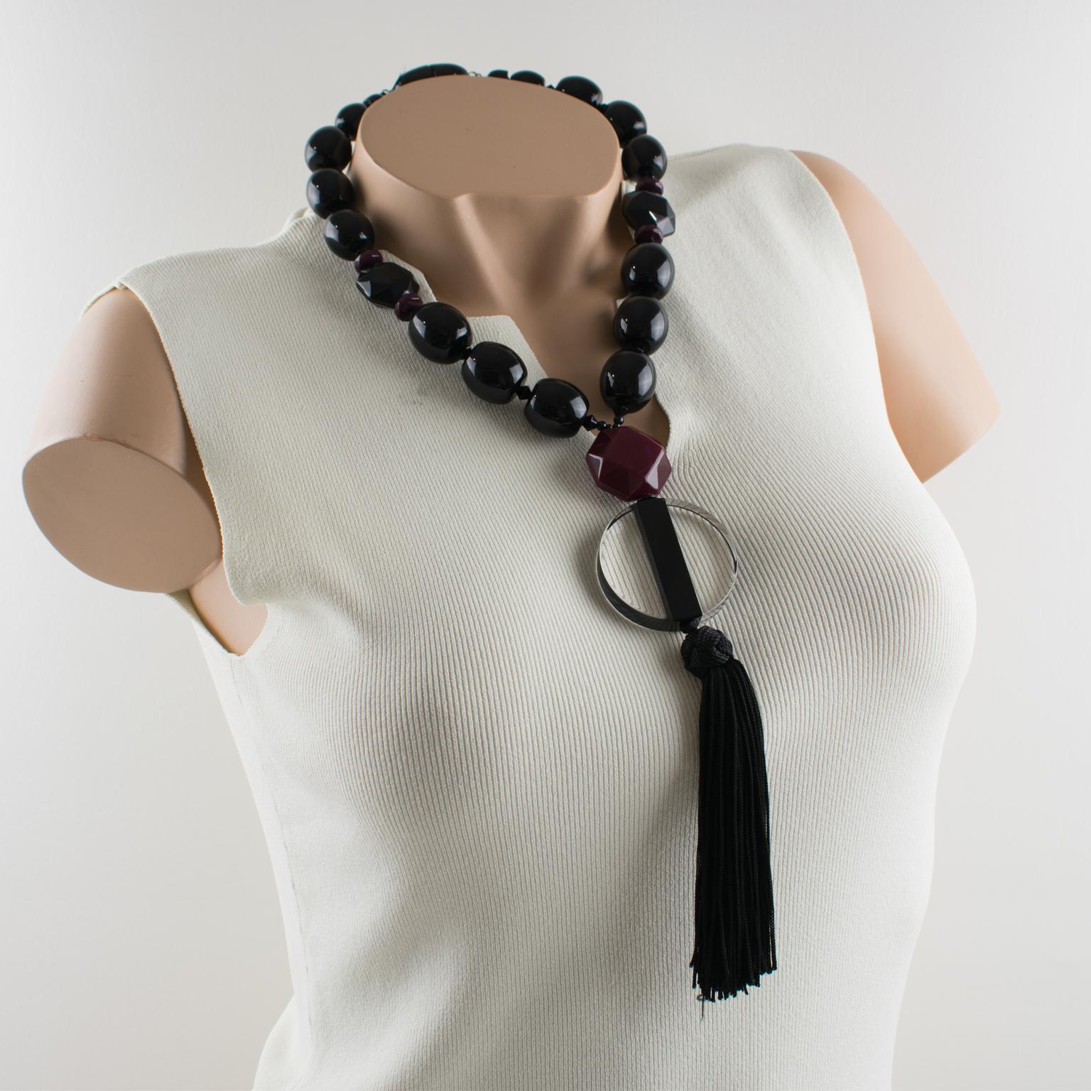 Refined Angela Caputi, made in Italy long beaded necklace. This flapper-style necklace has an Art-Deco-inspired design built with black resin beads complimented with purple grape faceted spacers and ornate with a Lucite pendant. The pendant starts