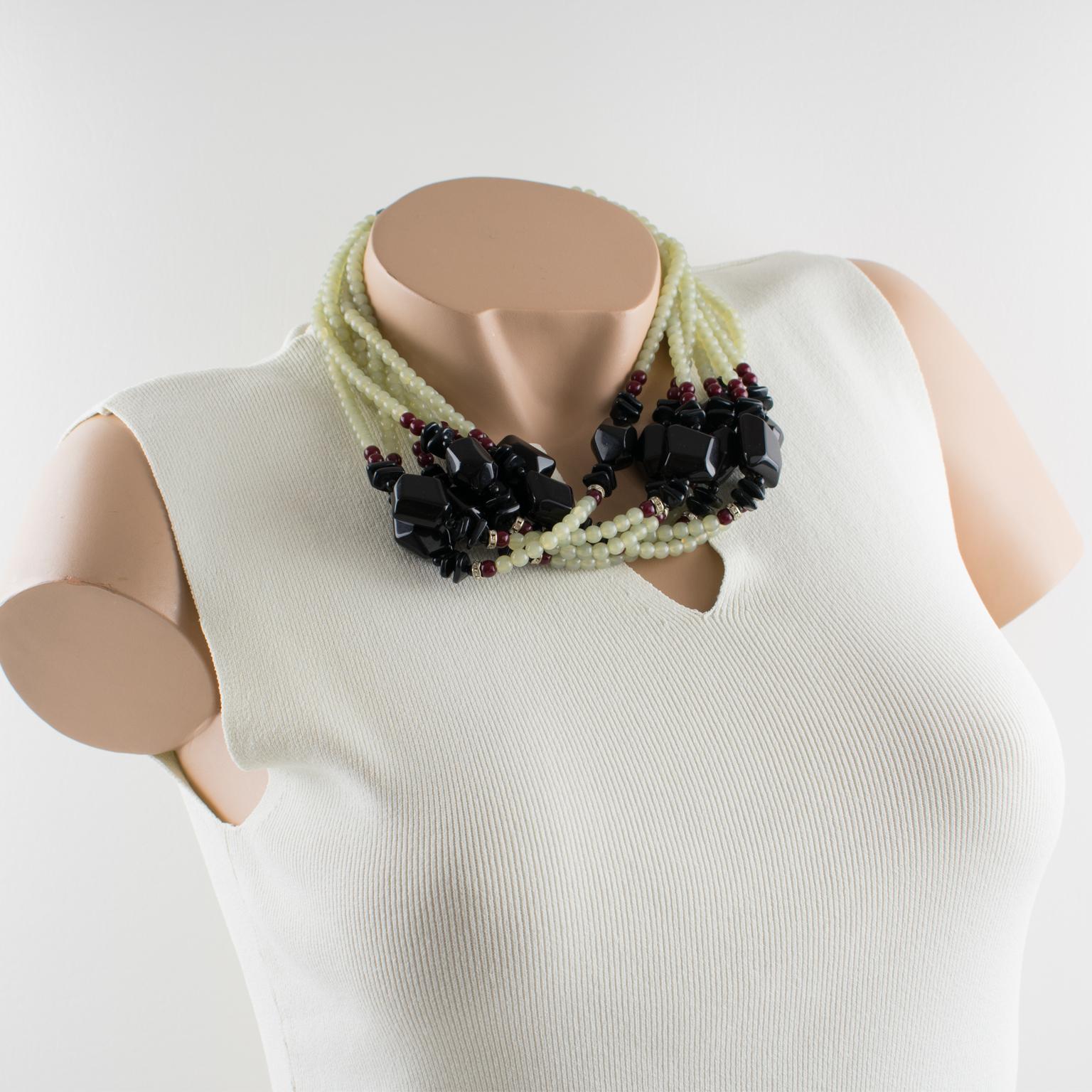 This stylish Angela Caputi, made in Italy, multi-strand beaded choker necklace is made of three colors of resin beads with seven strands. Assorted color range with black, burgundy red, and aqua green and complimented with crystal clear rhinestone