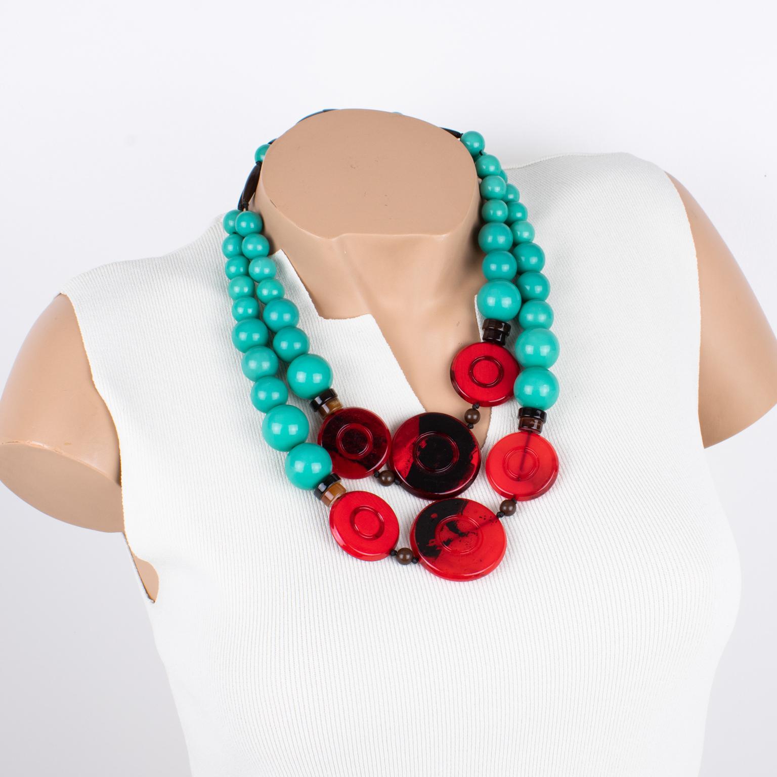 Angela Captui, an Italian designer, designed this outstanding resin-beaded necklace. The choker is predominantly teal green, strikingly contrasting red and black. Each rounded pebble bead is carved and dimensional. Caputi's color matching is always