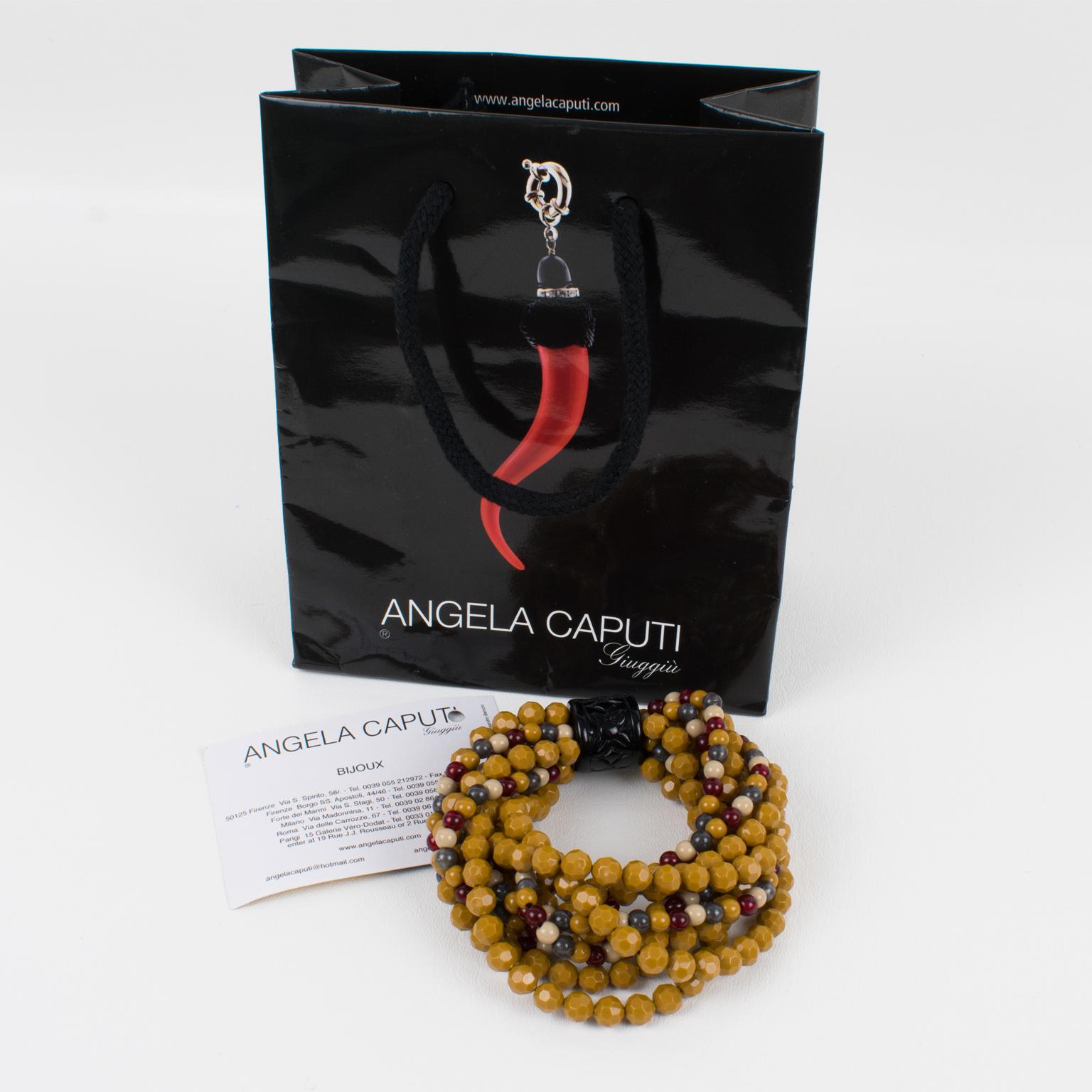 Lovely Angela Caputi, made in Italy resin beaded bracelet. Oversized multi-strand design with faceted beads in burgundy red, light beige, gray, and yellow Dijon mustard colors. B
The bracelet is built on stretch links so one size fits all. Her