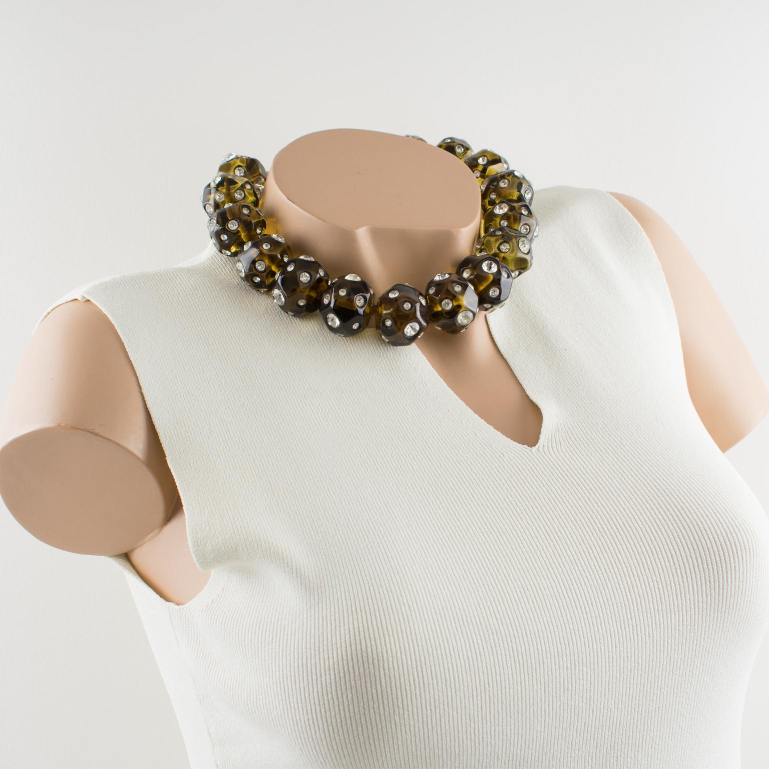 Striking and rare Angela Caputi, made in Italy choker necklace. Around-the-neck shape builds with large asymmetric resin beads in transparent olive green color all ornate with crystal clear rhinestones. Her matching of colors is always bold and
