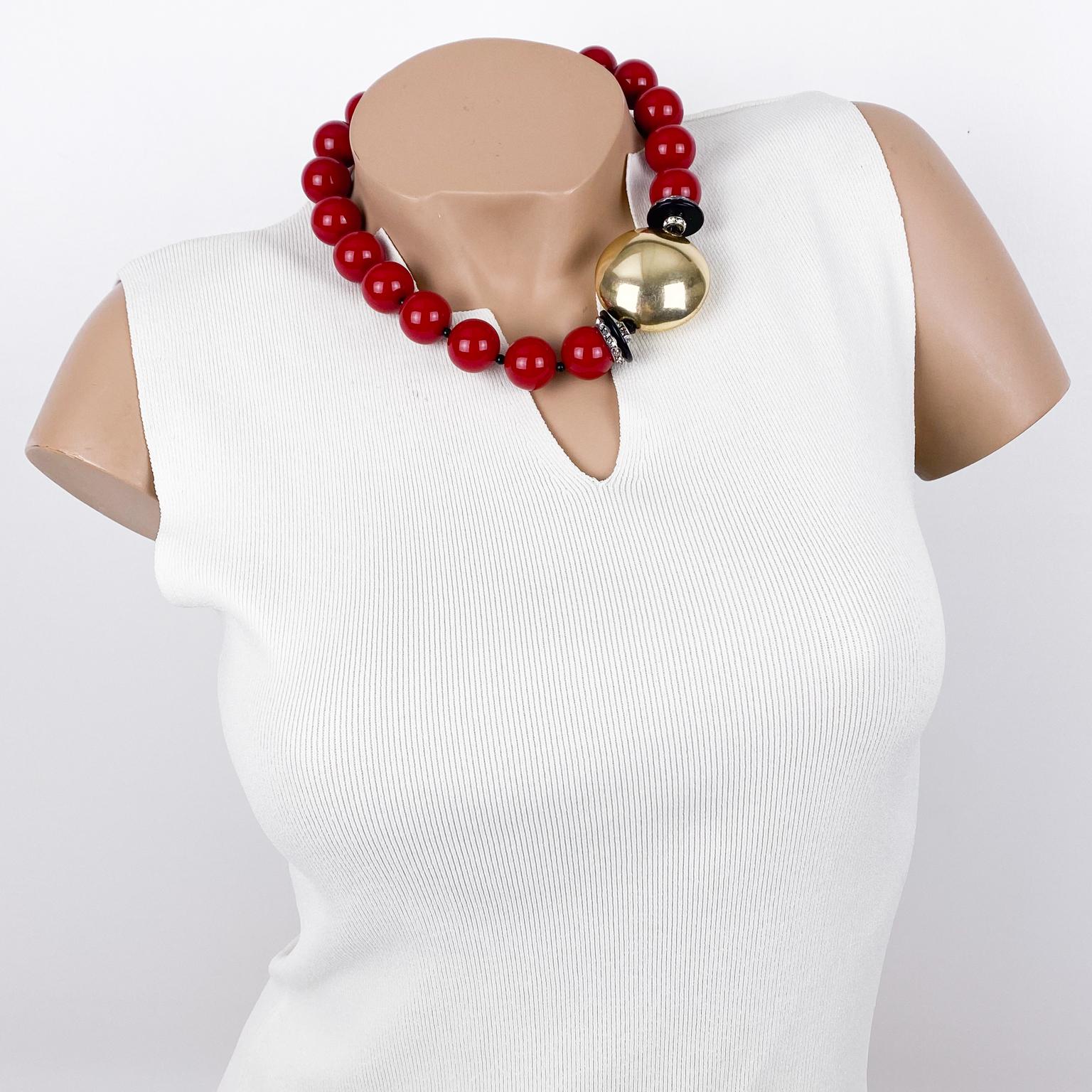 This classic Angela Caputi resin choker necklace, made in Italy, works in red and gold contrast with an asymmetric building. It features chunky round beads with a massive gilded metallic resin-coated bead on the side ornate with crystal rhinestone