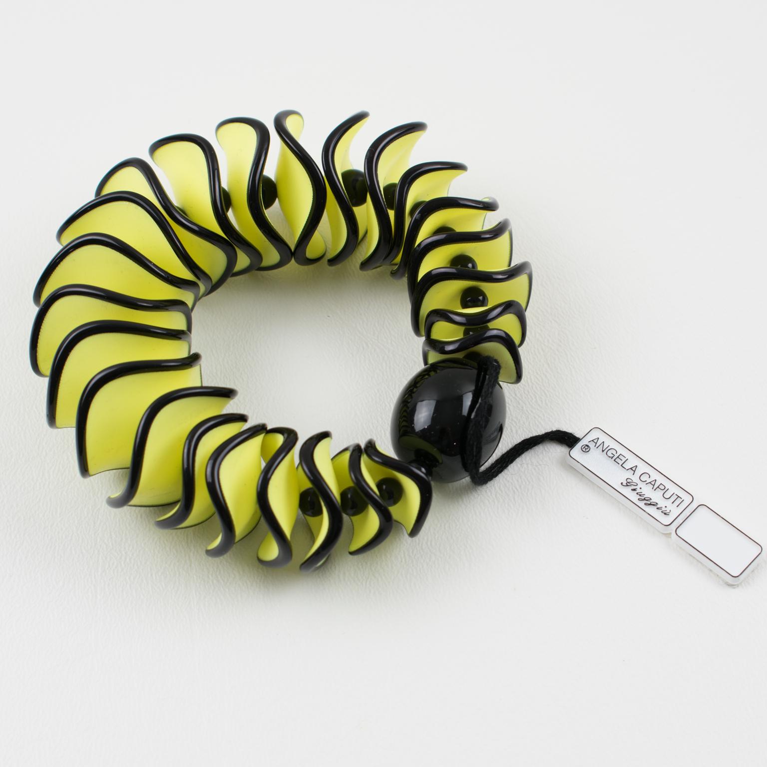 Stunning Angela Caputi, made in Italy resin bracelet. Oversized stretch design with vanilla yellow and black colors dimensional elements in a wavy shape with large central black bead, from the Flamenco collection. Her matching of colors is always